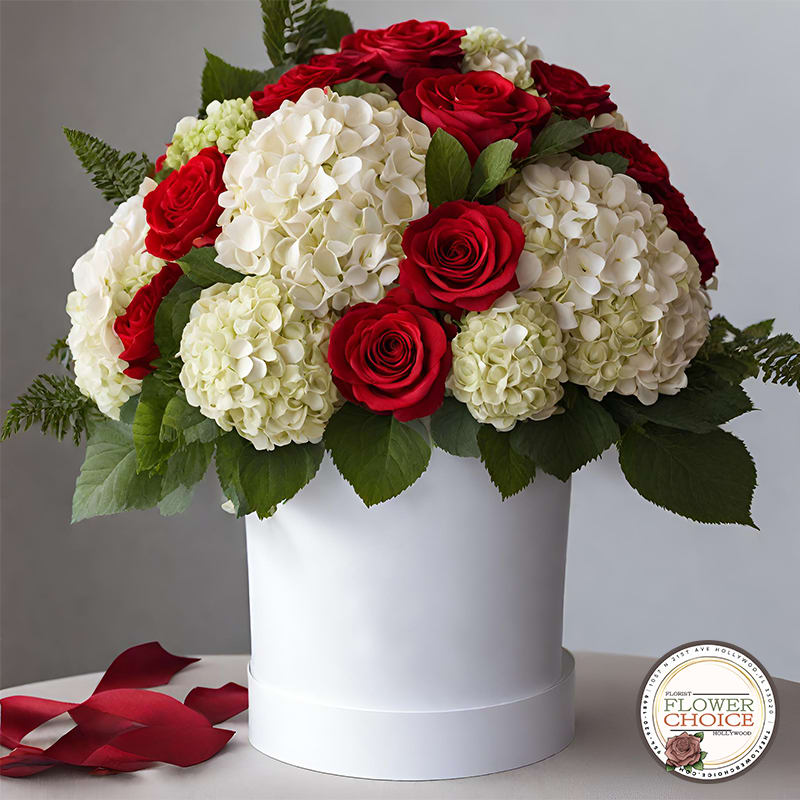 Whispers of Romance - Unveil the magic of romance with a captivating blend of roses and hydrangeas in a soft white hat box. Whispers of Romance convey a subtle charm, perfect for expressing tender emotions.