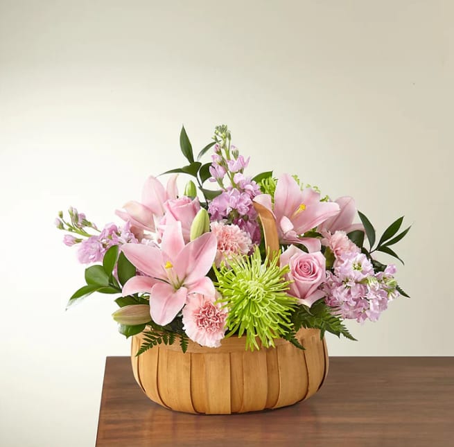 Beautiful Spirit Basket - Let them know how much you care with a gorgeous bouquet that features carnations, stock, roses, lilies and Fuji mums. Each bloom is a thoughtful reminder of your support and love, while sitting in a beautifully crafted basket.  Please Note: The bouquet pictured reflects our original design for this product. While we always try to follow the color palette, we may replace stems to deliver the freshest bouquet possible, and we may sometimes need to use a different container.
