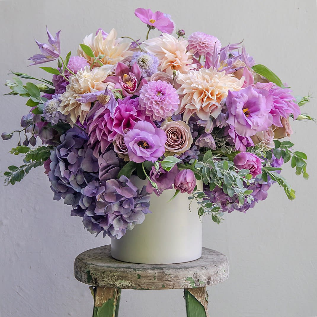 The Taking Fluffy to the Next Level Arrangement. - This Queen requires 24 hours notice...She's so demanding, but well worth it to wait for Her Petal Royalty.  Seasonal Soft Lavenders and the Palest of Peaches.  Seasonal varieties include Dahlias, Garden Roses, Amnesia Rose, Lisianthus, Cosmos, Tulips &amp; Clematis.  