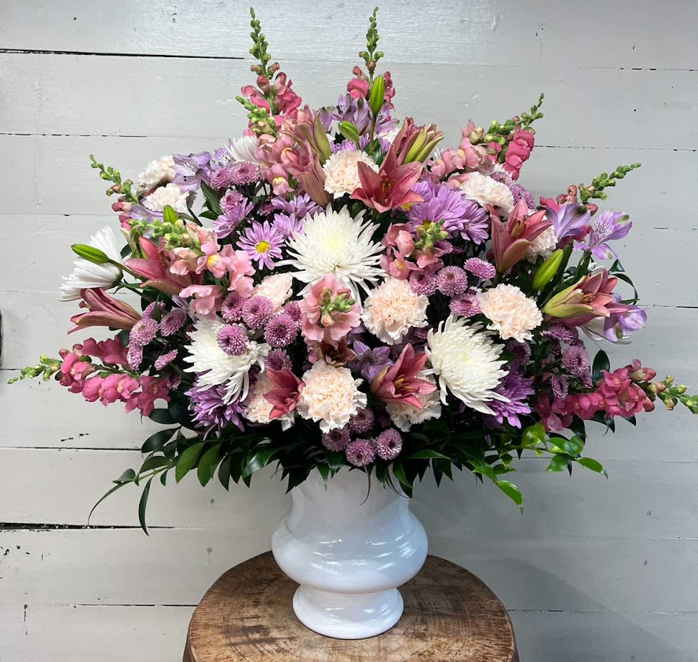 Forever In Harmony Urn Funeral Arrangement - This pink, lavender and white urn funeral arrangement is a lovely sendoff and tribute. Fitting for any type of ceremony. 