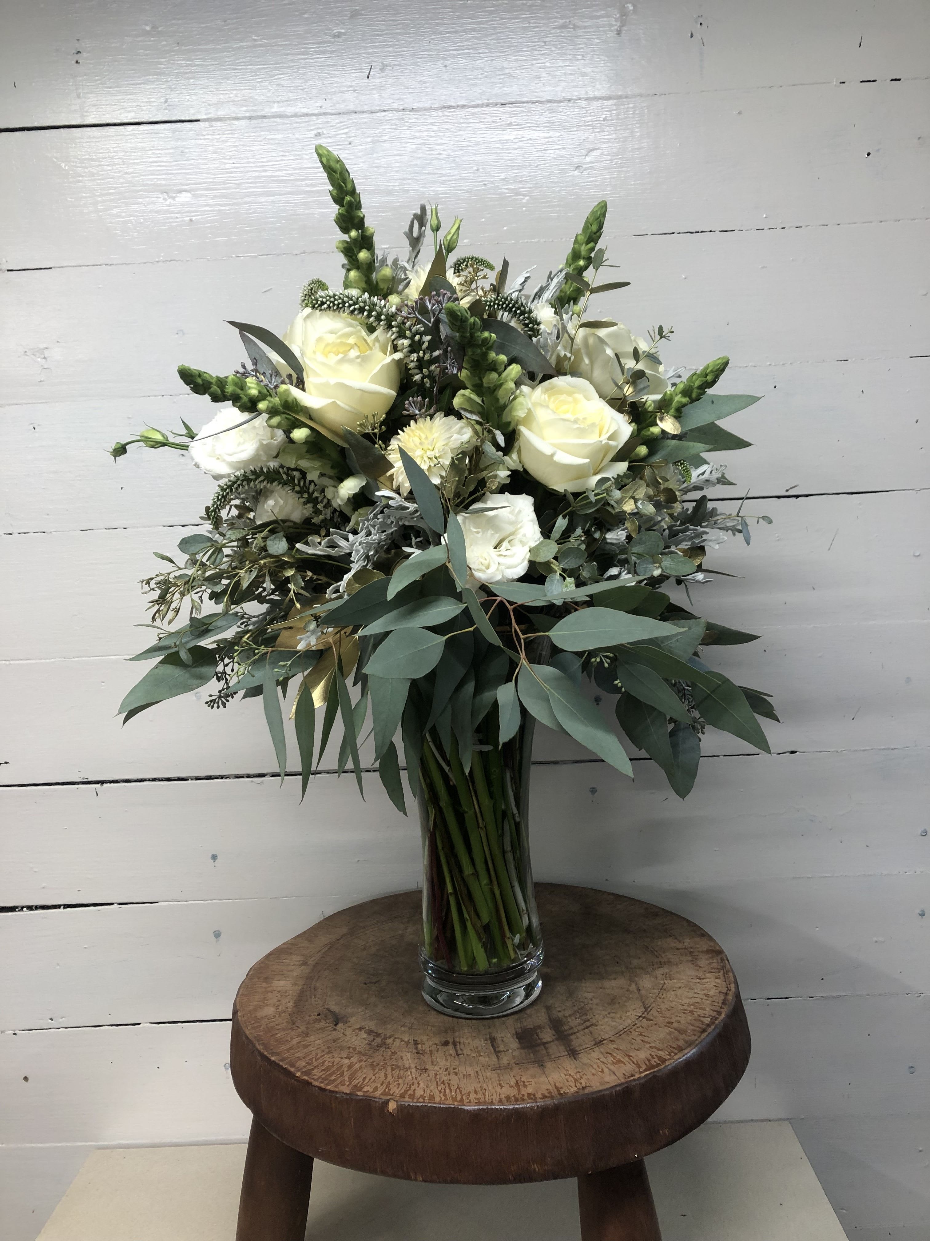 Celebrate in Style Celebrate in Style - A stunning arrangement of white roses, veronica, snapdragons, and lisianthus accented with gold-flecked eucalyptus.