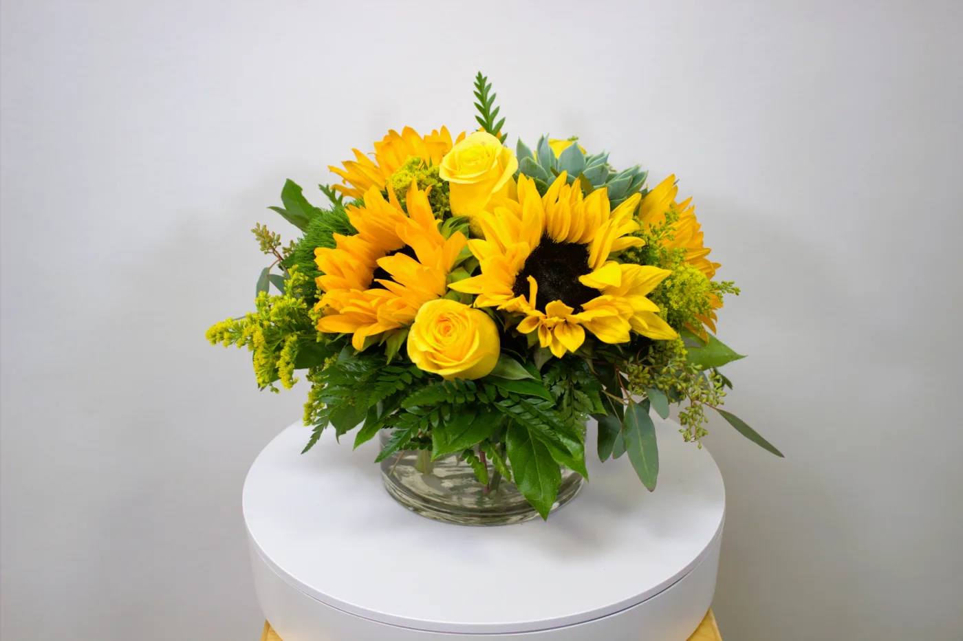 Sweet Honey 0062 Sweet Honey 0062 - Low and Lush Arrangement with Sunflowers, Yellow Roses, Solidago and Greenery in a Glass Vase