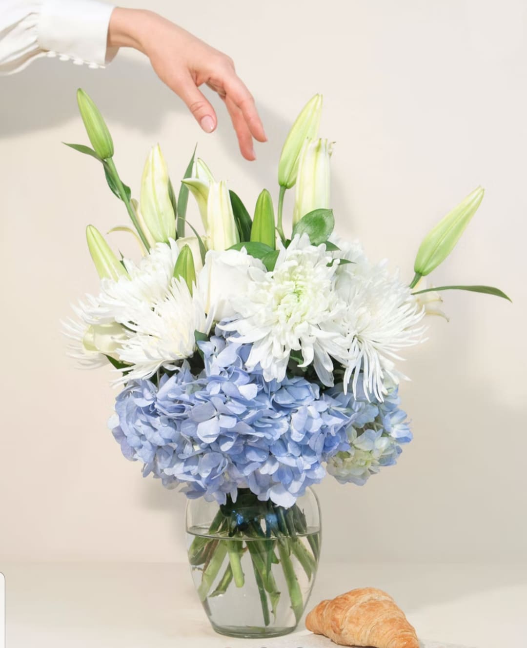Sweet Serene 0068 - This peaceful flower arrangement is one of our favorites. The combination of blue hydrangea, chrysanthemums, white lilies, and roses is stunning.