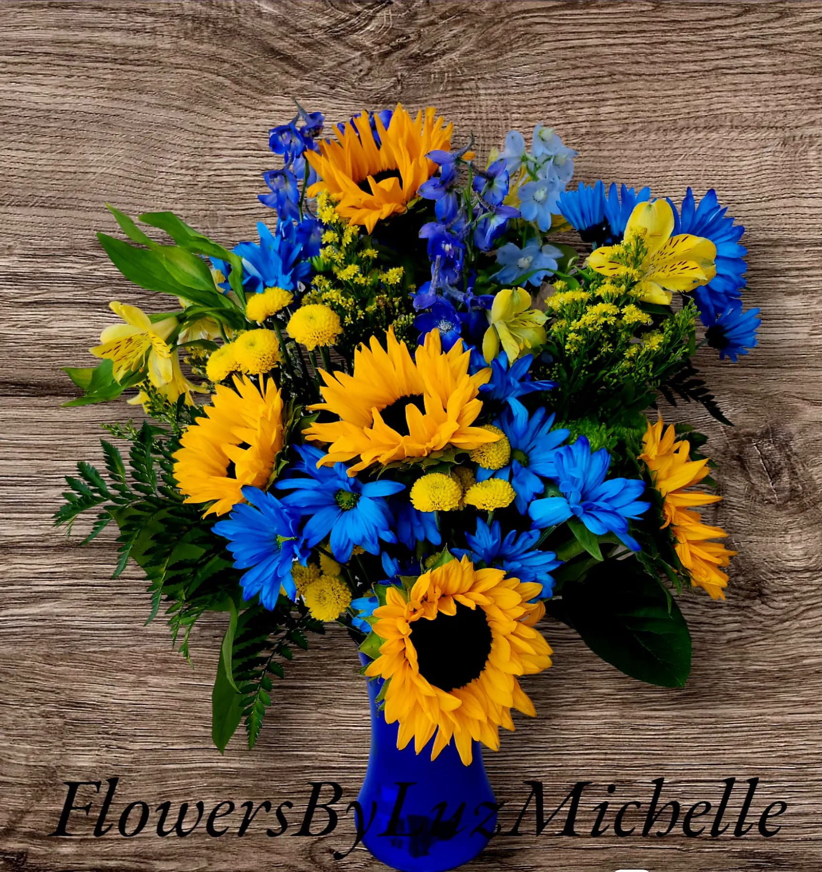 Summer Blues - Enjoy this vibrant bold summer blues and yellows. Brighten any room or special someone. Yellow subflowers and seasonal blue flowers