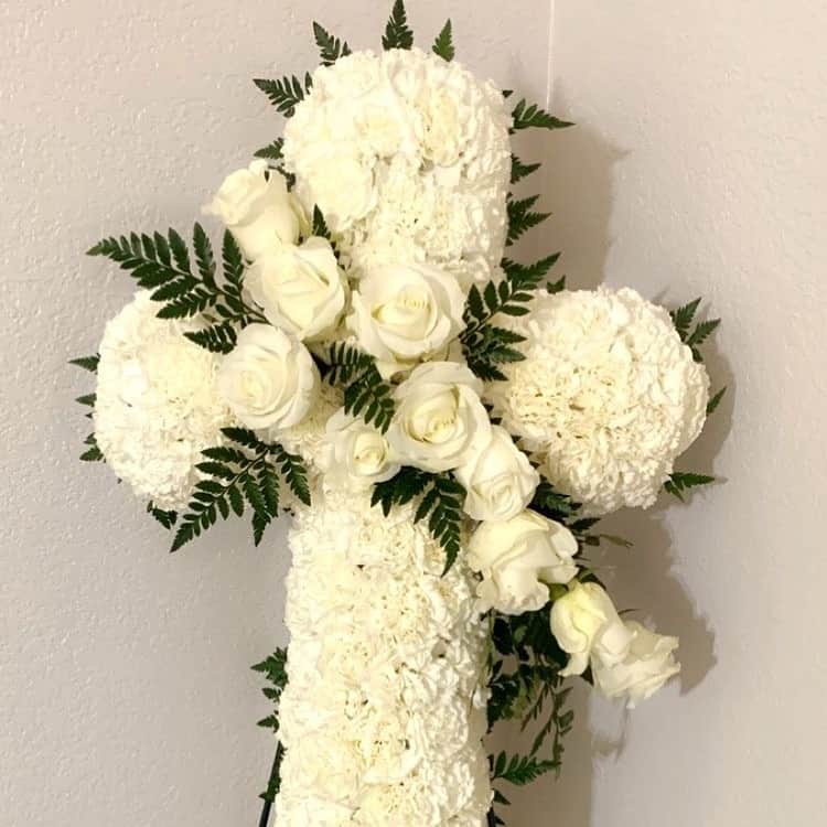 White Mix Cross White Mix Cross - Offer Comfort and Serenity with White Mix Cross. Elegant cross-shaped wreath, adorned with pure white dianthus and graceful roses, serves as a heartfelt symbol of remembrance and solace.