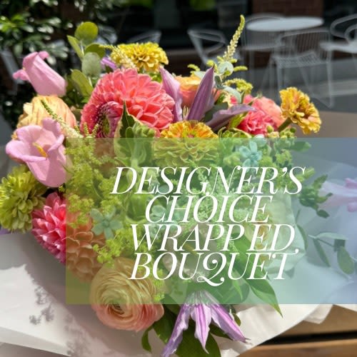 Seasonal Designers Choice Wrapped floral arrangement Seasonal Designers Choice Wrapped floral arrangement - Let our talented team of designers create a floral arrangement perfect for your occasion. All arrangements are unique and one of a kind. This arrangement is a hand tied bouquet, no vase is included