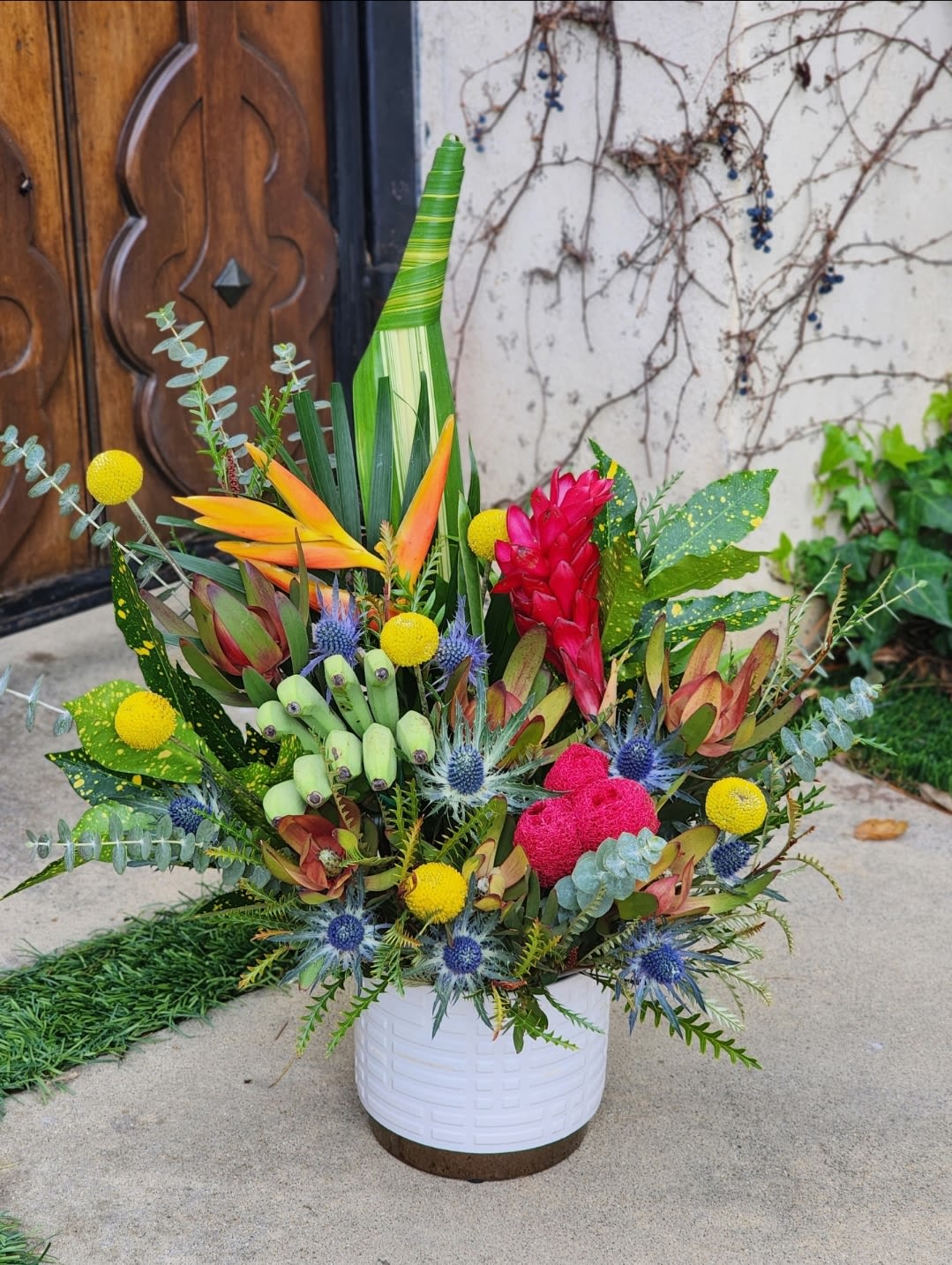 Tropical Breeze - This vibrant tropical arrangement features an exotic mix of bold colors and textures. eye-catching display perfect for special occasions or home, office decor 