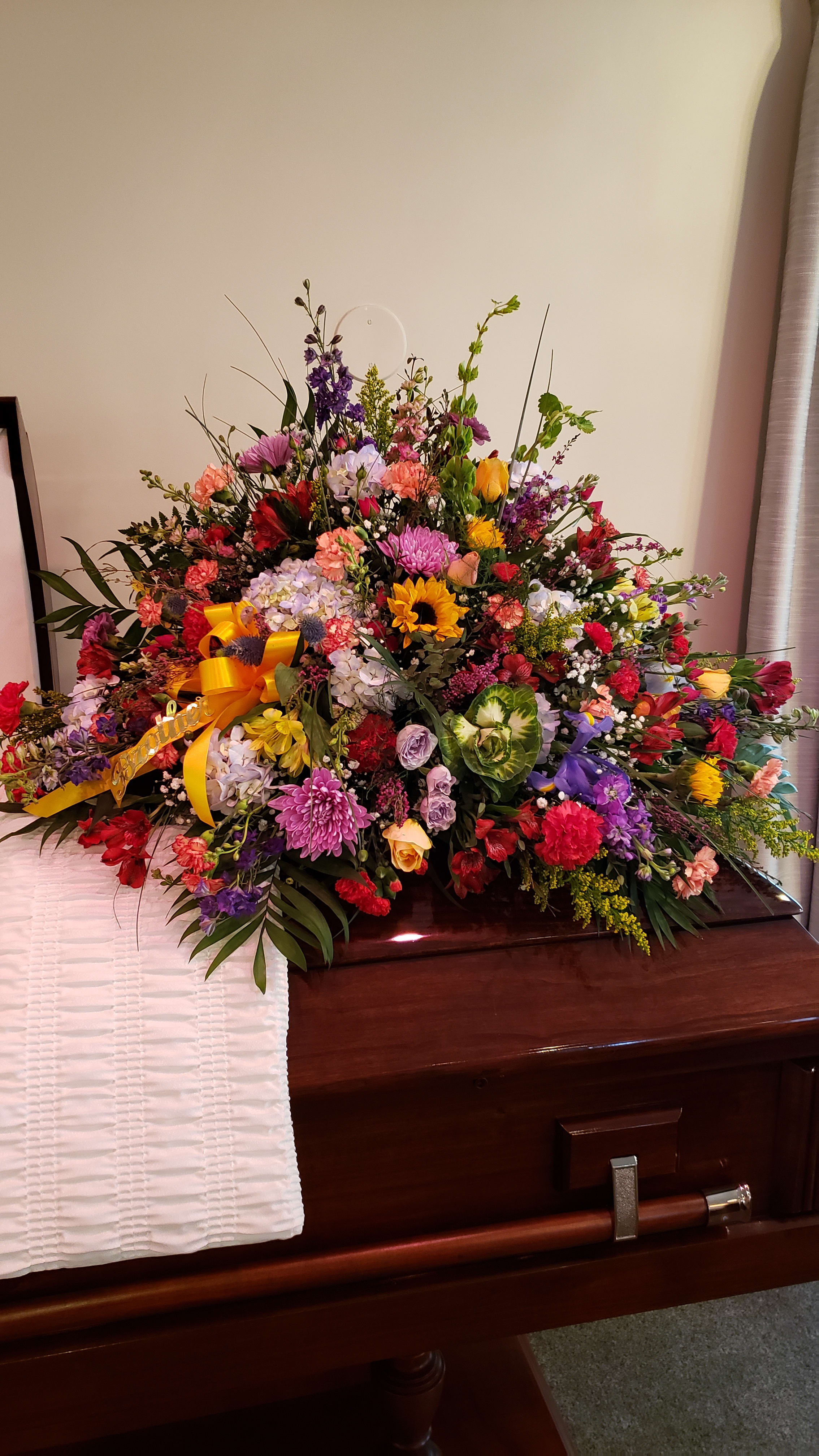 Full of blooms - Casket cover...for open or closed...just let us know for proper design width. Mixed florals &amp; colors would be based on fresh market availability at time of order &amp; delivery time/date. Design in photo can vary with use of other floral stems the designer made need to use to meet value.  Let us know a few of your color choices... This sample is a &quot;colorful mix&quot; great garden of colors.
