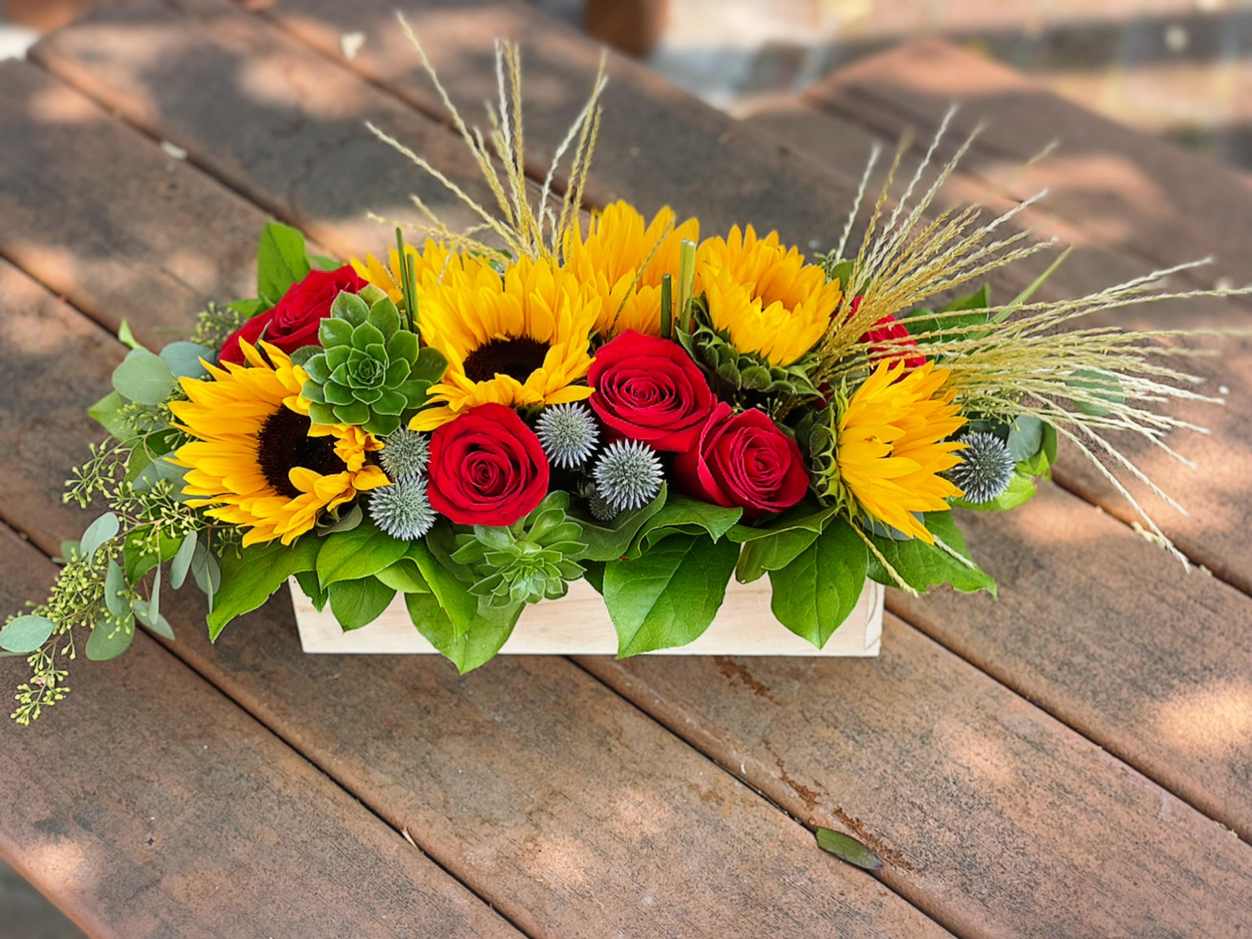Urban (Sunflowers) - - 5 Sunflowers - 6 Red Roses - 2 Succulents - 2 Silver Feather - Greenery - 12 x 4 Inches Wooden Box