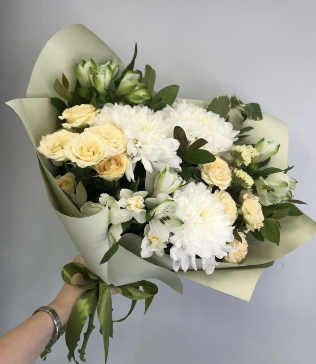 Hand -Tied  - A wonderful bouquet of flowers hand-tied together as if picked from the blooming meadow or garden. Flowers and colors of the season to make a perfect floral gift. 