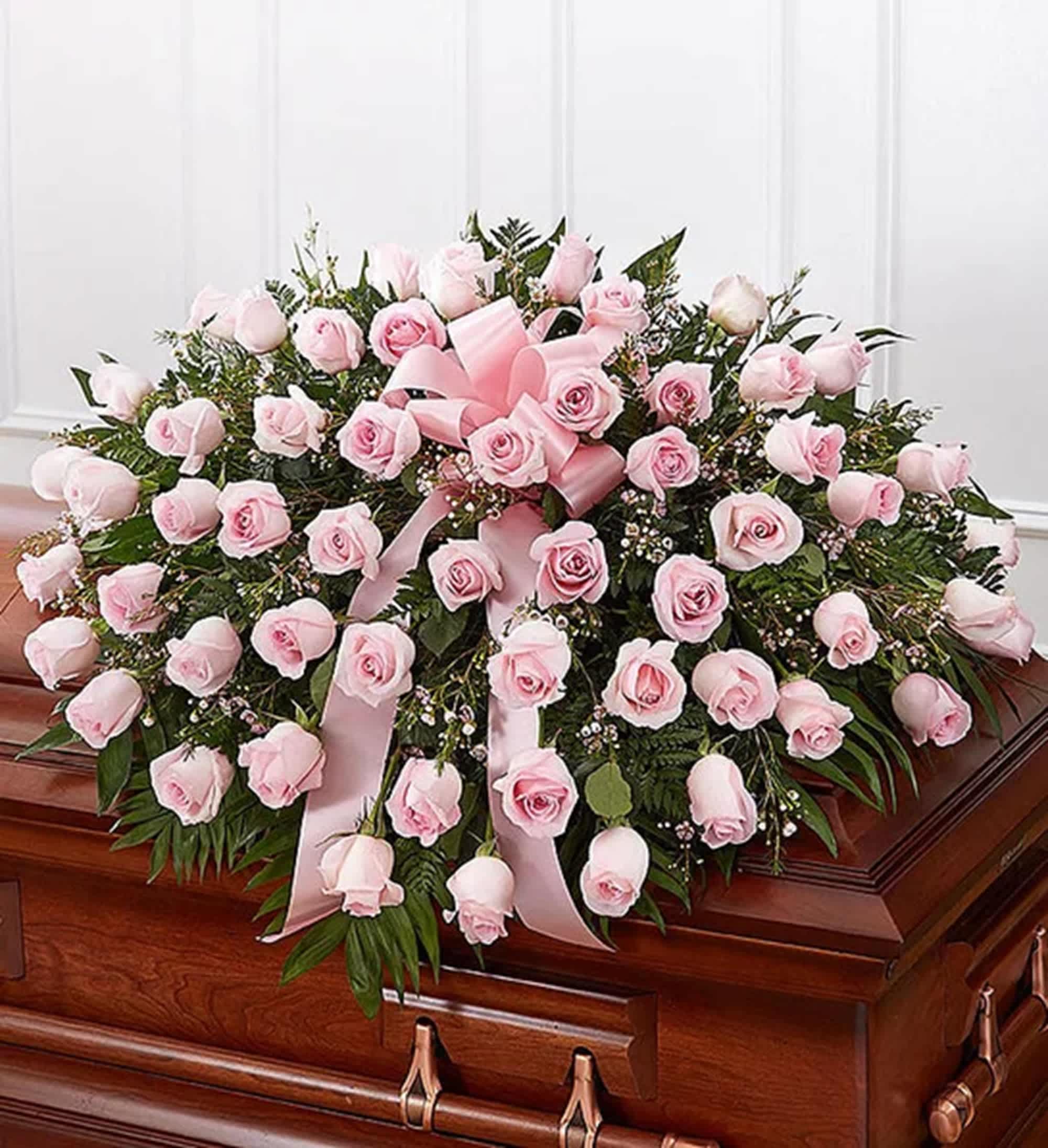 Pink Rose Half Casket Cover - The ultimate symbol of grace, love and admiration, soft pink roses are a sentimental way to honor someone who was deeply cherished. Our half casket cover, crafted with care and artistry with soft-hued blooms is an unforgettable way to commemorate a lifetime of unconditional love.   DETAILS Half casket cover arrangement of pink roses, waxflower &amp; greenery. Traditionally sent by the immediate family to the funeral home.  Orientation: All-Around  *If you would like to add a ribbon with a sentiment for an additional $10 each. Item #NF-1118  FLORIST-TO-DOOR Same day flower delivery on most orders placed online by 12 pm or 10 am on weekends PST.  BLOOM DETAILS Roses Waxflower  Greenery  The Standard Arrangement is approx. 16&quot;H x 36&quot;L x 28&quot;D (SHOWN) 50 Roses The Deluxe Arrangement is approx. 17&quot;H x 37&quot;L x 29&quot;D The Premium Arrangement is approx. 18&quot;H x 38&quot; x 30&quot;D  INSTRUCTIONS: 1.) Please have the business name of the funeral home, address &amp; phone number 2.) Please have the first name &amp; last name of the deceased 3.) Please have the start time of the services 4.) If you would like for us to write a brief message on a small business card-size note, please have your message ready  How to place an order? 1. You can place an order directly on this secure website OR 2. You can call in your order by dialing: (323) 262 - 9238 OR 3. You can visit our store (appointment recommended 323.262.9238)  NINFA'S FLOWERS 2405 WHITTIER BLVD. LOS ANGELES, CA. 90023