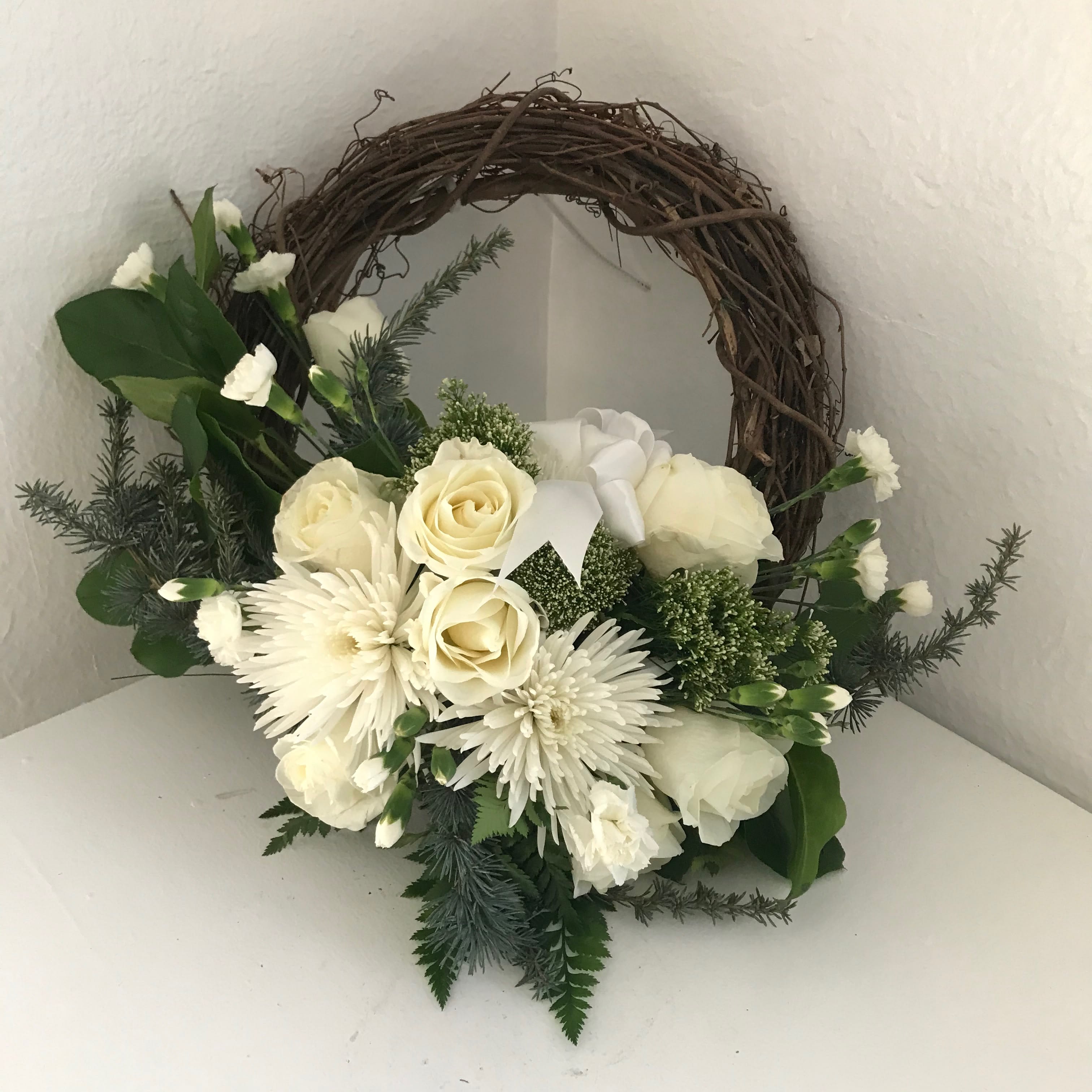 Serene vine wreath - White flowers and rich greens on a grapevine wreath