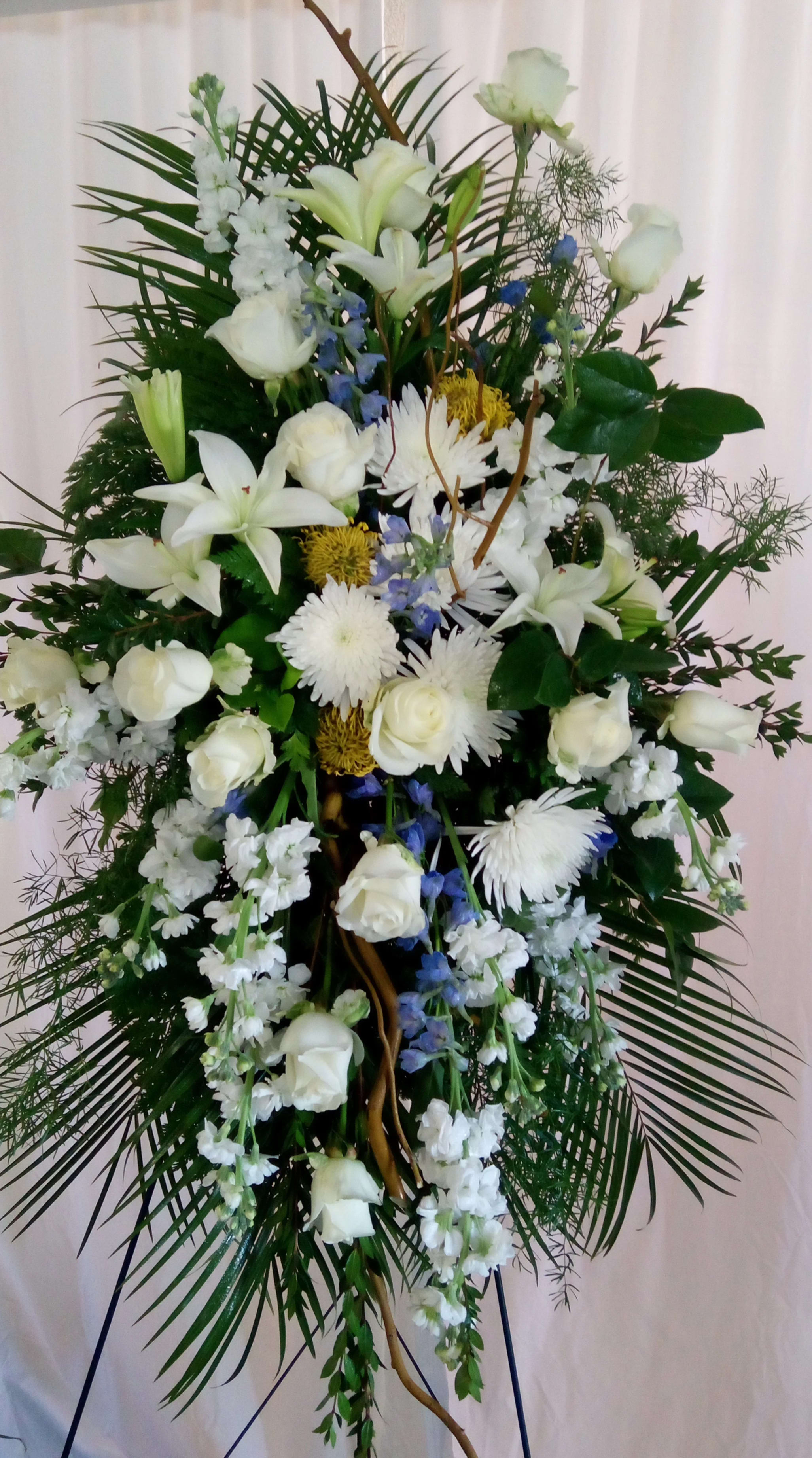 Life's Glory  - Mostly white standing spray with subtle touches of yellow and blue