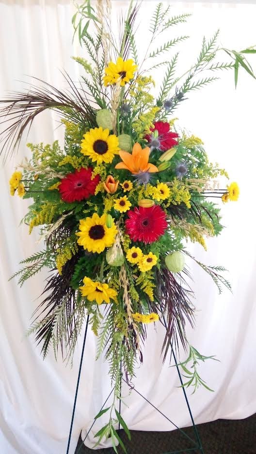 One Day At A Time - Yellows, oranges and reds round out this standing spray with a celebration of color