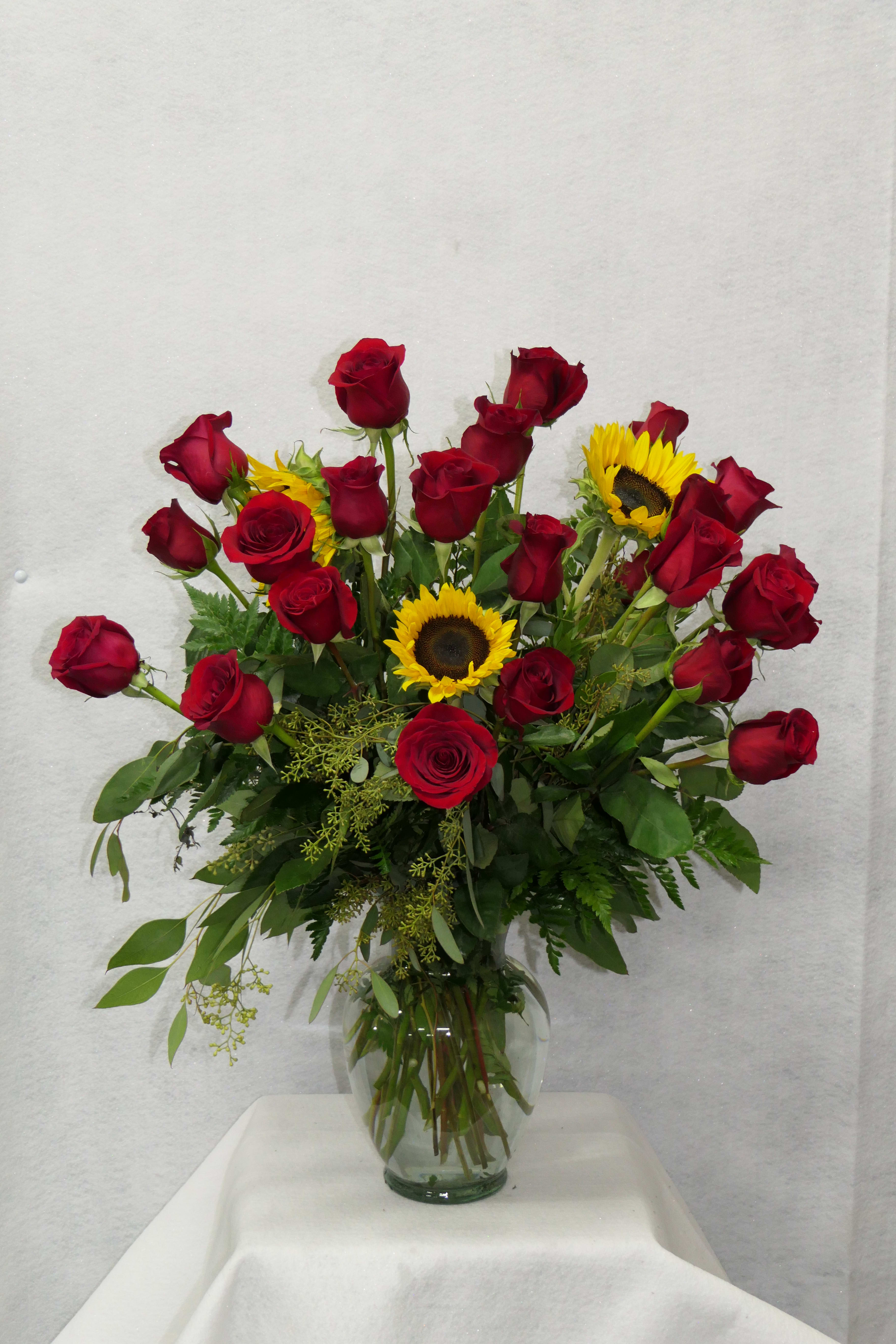 Dozen Red Roses with Sunflowers Dozen Red Roses with Sunflowers - 12 long red roses accompanied with sunflowers