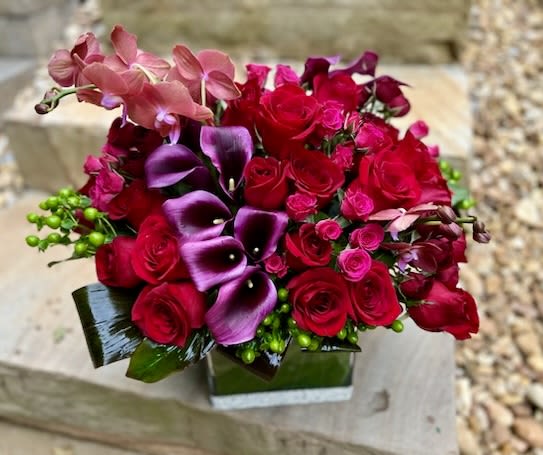 Calla &amp; Orchids - A deep colored modern arrangement with beautiful orchids, calla lilies and a variety of roses.  If same day delivery is needed, please give us a call to arrange this.