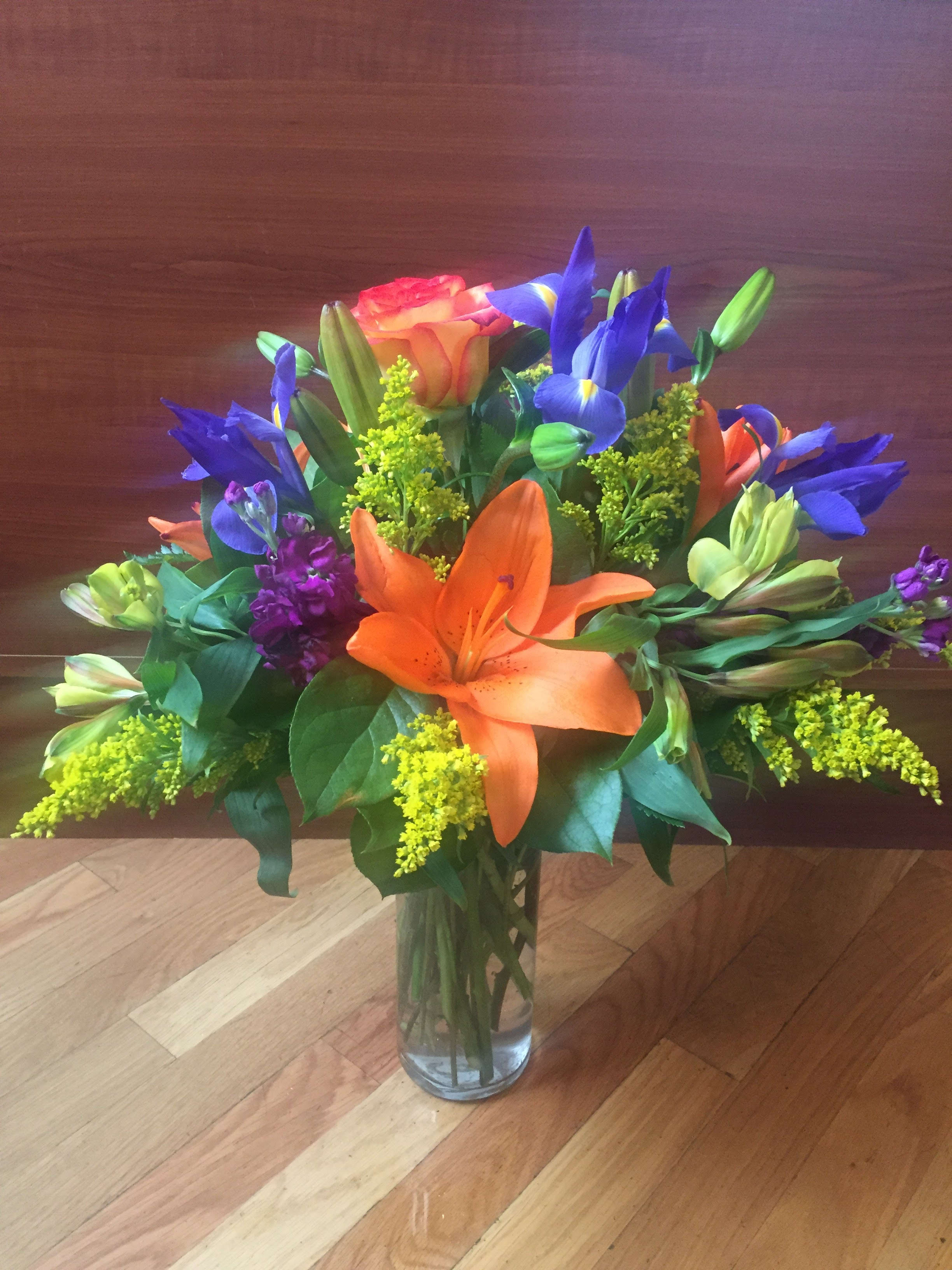 mixed beauty  - this daisy, iris, and roses arrangement will be a perfect gift 