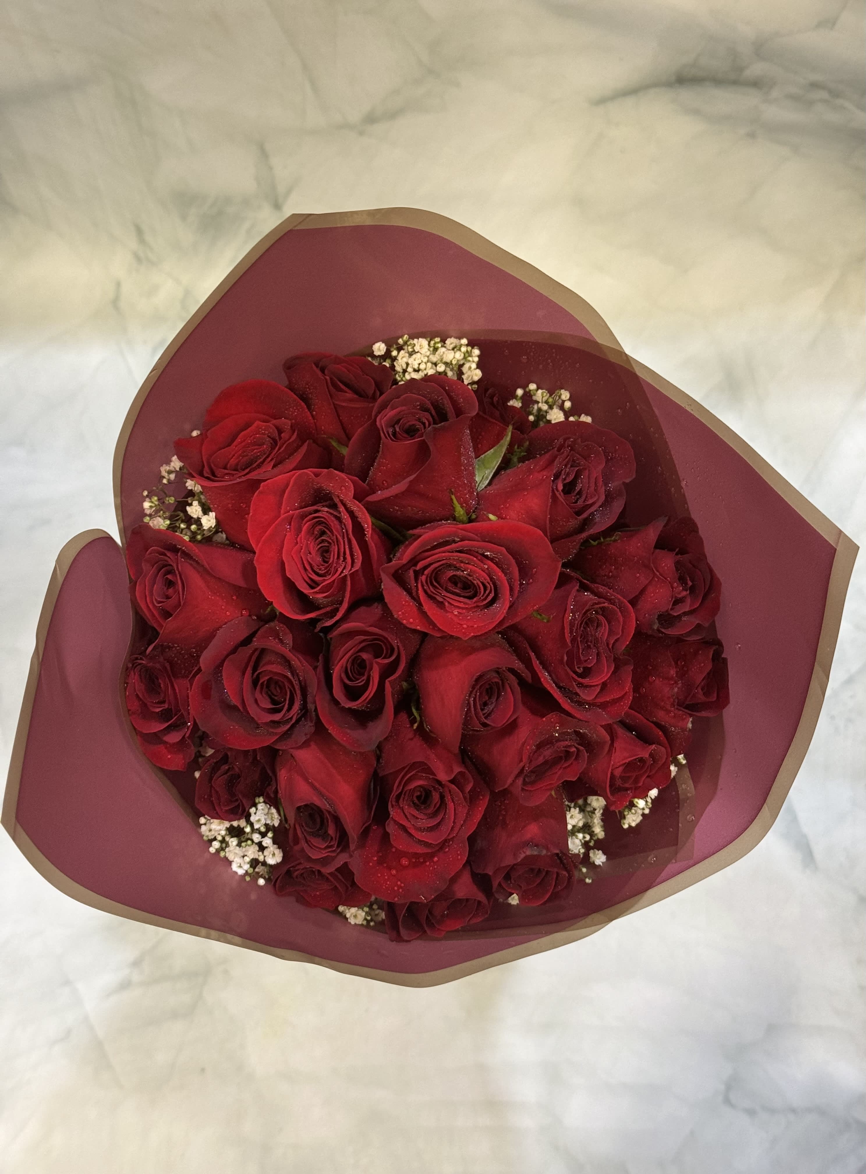 Love and Romance Rose Bouquet - This bouquet includes 24 classy red roses wrapped in special waterproof floral wrapping paper. They are designed in a perfectly round bouquet. 