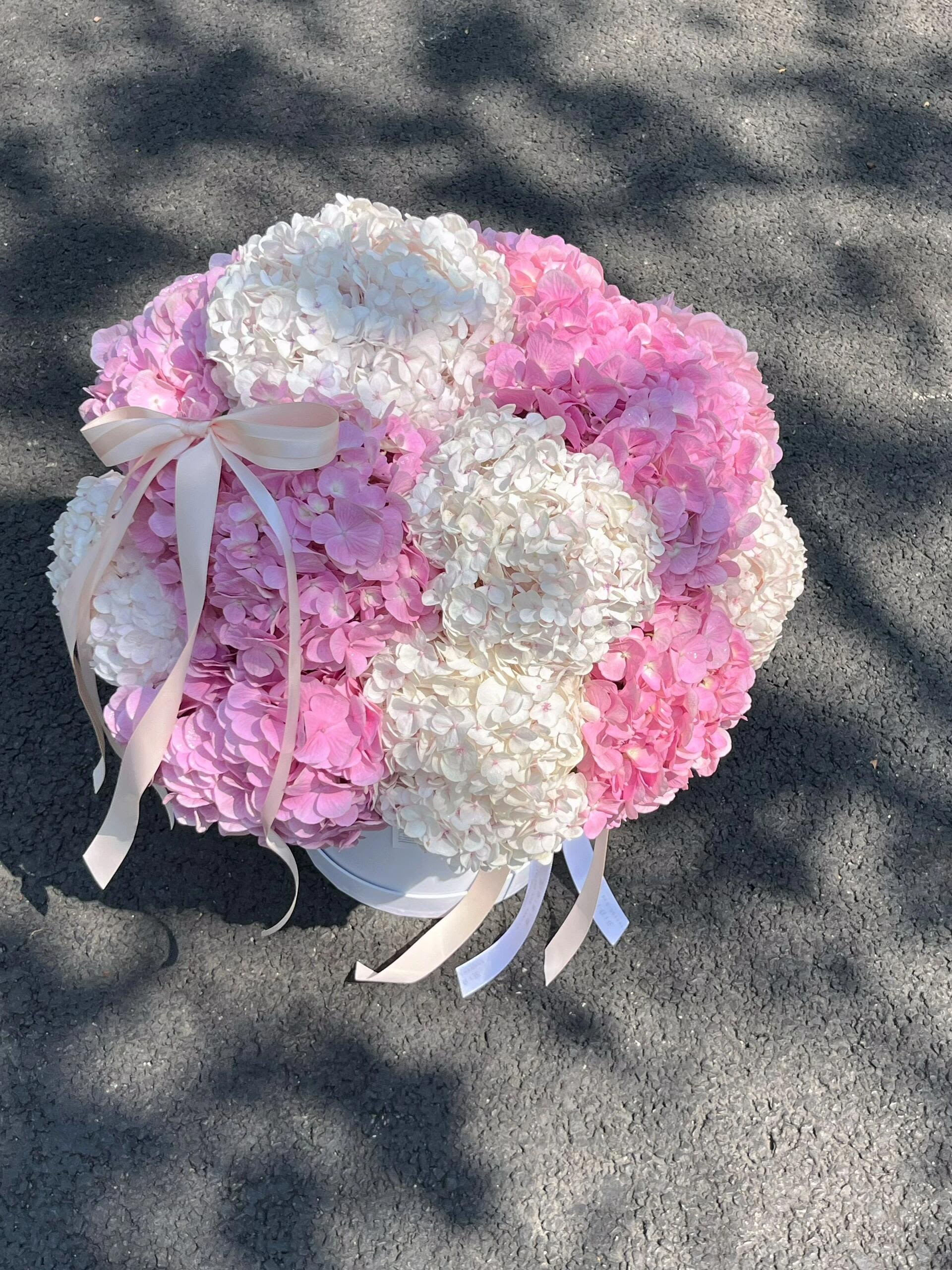 Bella Bloom - The product includes white hydrangeas, pink hydrangeas, ribbon bows, and hug buckets.