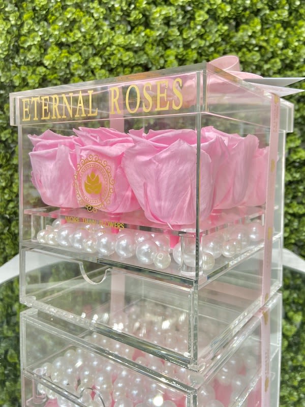 Eternal Roses Acrylic Box (9 Roses) - Light Pink - Eternal Roses Acrylic Box (9 Roses): We stopped the clock for our preserved roses to experience our Eternal Deluxe Collection timelessly. 9 preserved roses decorated in our signature deluxe clear acrylic boxes and completed with a bow and a personalized card message, trendy and fancy. Roses that Last 3 years. *Avoid direct sunlight, dust, water or excessive heat. *Available for Nationwide Shipping (5-7 days shipping time)