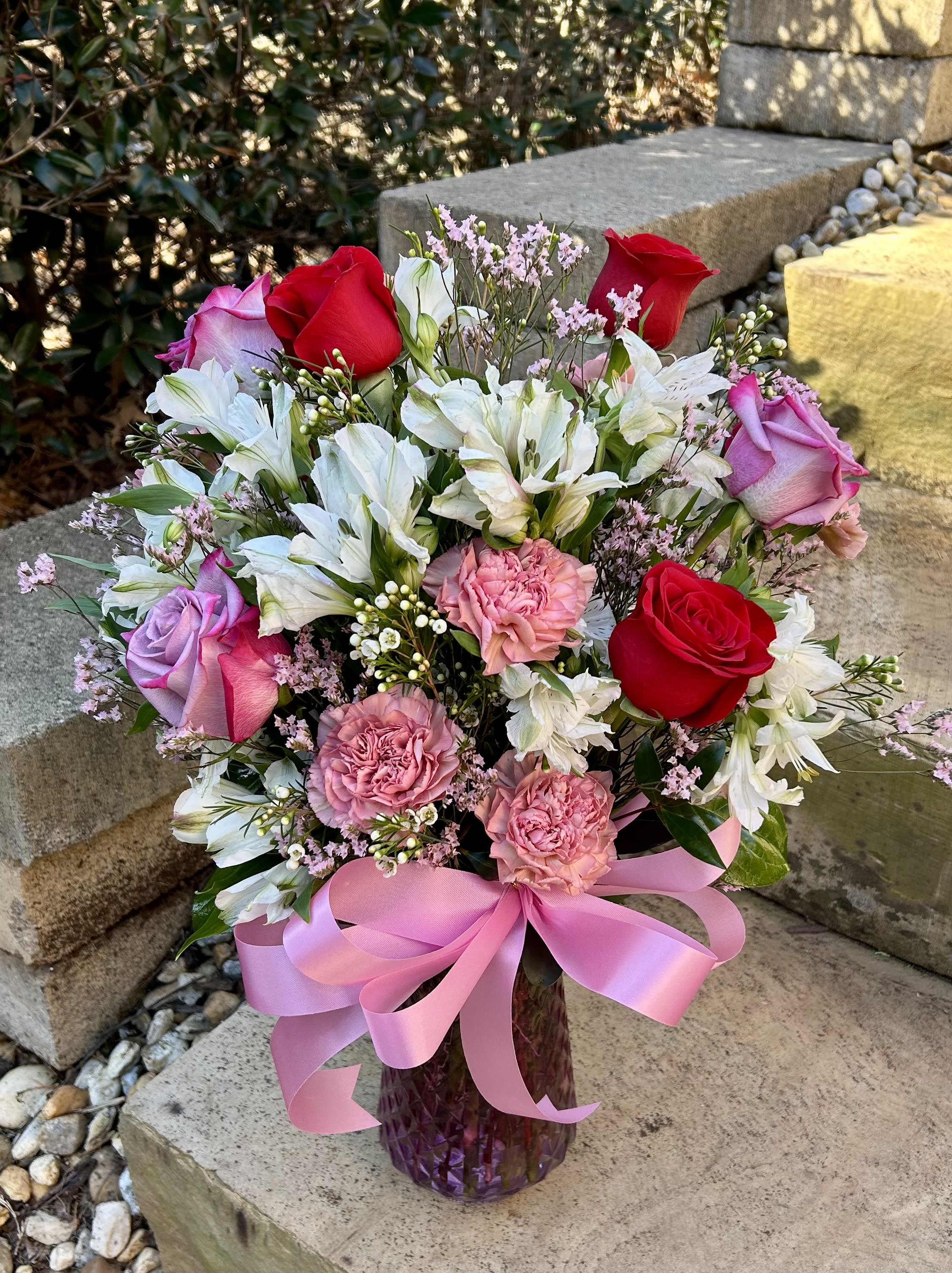 Pink Romance Pink Romance - A beautiful pink, red and white arrangement in a pink vase with a beautiful bow to tie the bouquet together.