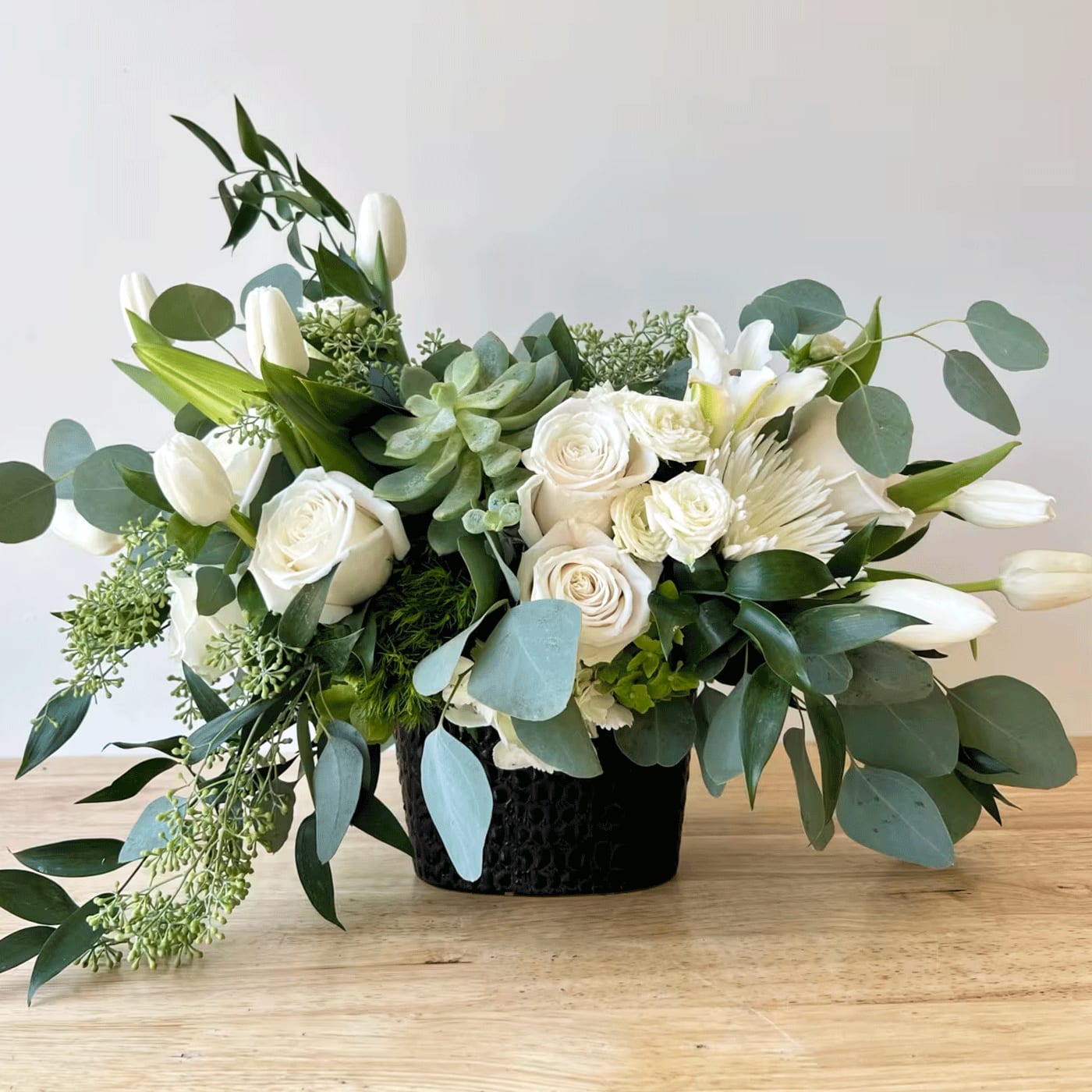 SNOW WHITE SNOW WHITE - SNOW WHITE - TULIP, SILVER DOLLAR EUK, ROSES, SPRAY ROSES, SEEDED EUK, ITALIAN RUSCUS, GREEN HYDRANEGA, DYANTHUS, + OTHER SEASONAL FLORALS