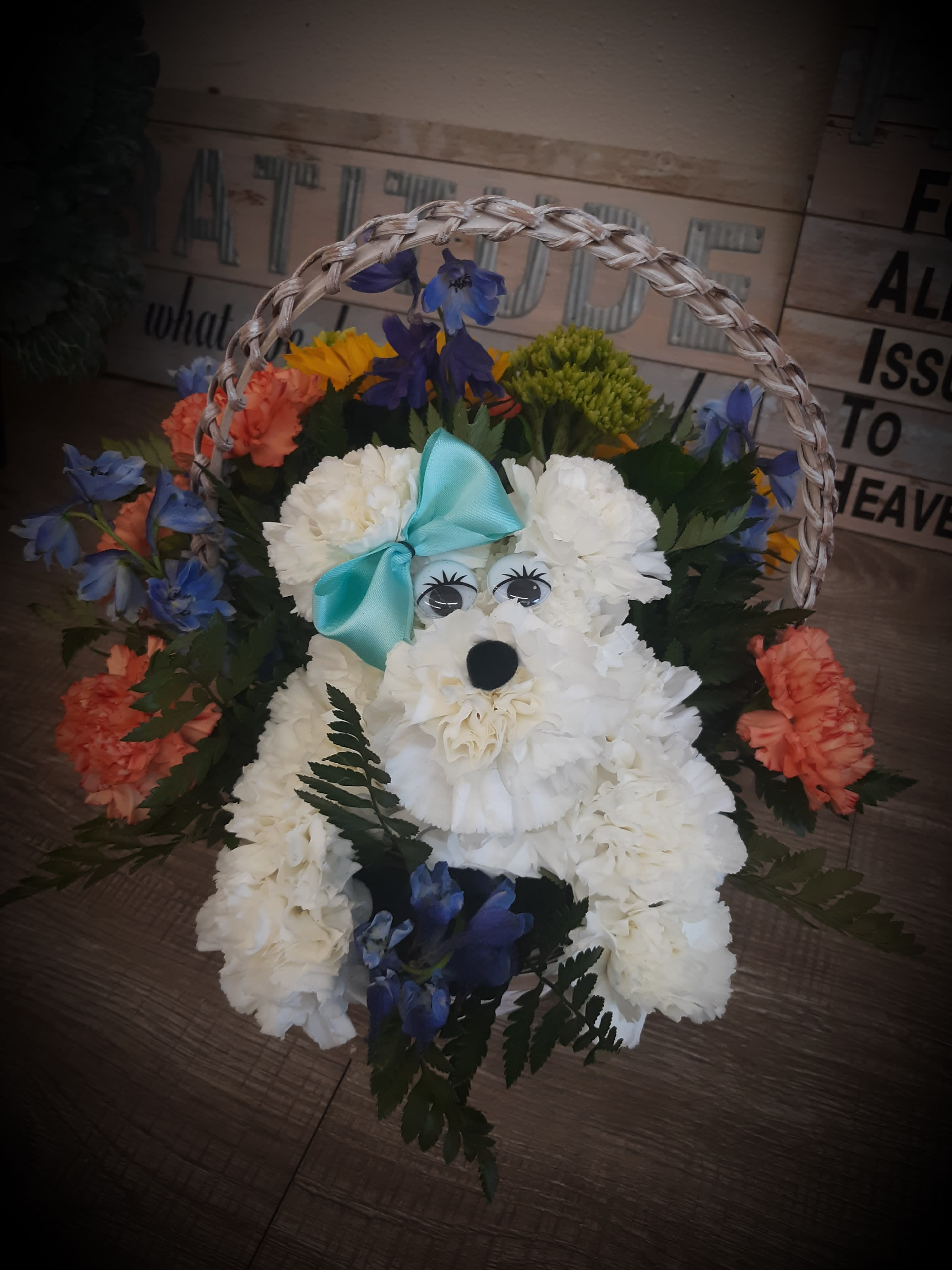 Garden puppy - Our darling puppy is made out of carnations and surrounded with a basket of fresh seasonal flowers.  The puppy pictured is surrounded by sunflowers, delphinium, orange carnations and green hydrangeas