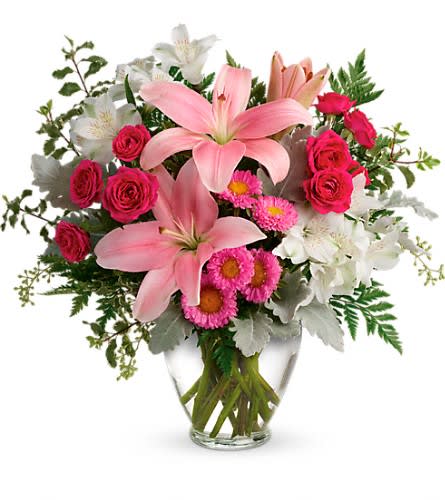 Blush Rush Bouquet Blush Rush Bouquet - Luxe lilies in a beautifully blushing shade of pink are sure to make them smile no matter the occasion! This pretty bouquet features hot pink spray roses pink asiatic lilies white alstroemeria pink matsumoto asters seeded eucalyptus leatherleaf fern dusty miller and pitta negra. Delivered in a Serenity Vase.Approximately 16 1/2" W x 15 1/2" H Orientation: One-Sided As Shown : TEV55-5ADeluxe : TEV55-5BPremium : TEV55-5C