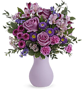 Teleflora's Prettiest Purple Bouquet -  Pretty as a picture, this perfect purple bouquet spoils your someone special with lavender roses and a graceful frosted glass vase.      Lavender roses, lavender alstroemeria, purple button spray chrysanthemums, purple matsumoto asters, miniature lavender carnations, lavender waxflower and lavender sinuata statice are arranged with parvifolia eucalyptus and variegated pittosporum. Delivered in Teleflora's Serendipity Glass Vase.     Orientation: All-Around   SUBSTITUTION POLICY – Always deliver the freshest flowers! Please note the bouquet pictured reflects our original design.  If the exact flowers or container in this arrangement are not available, our local florists will create a beautiful bouquet with the freshest available flowers.