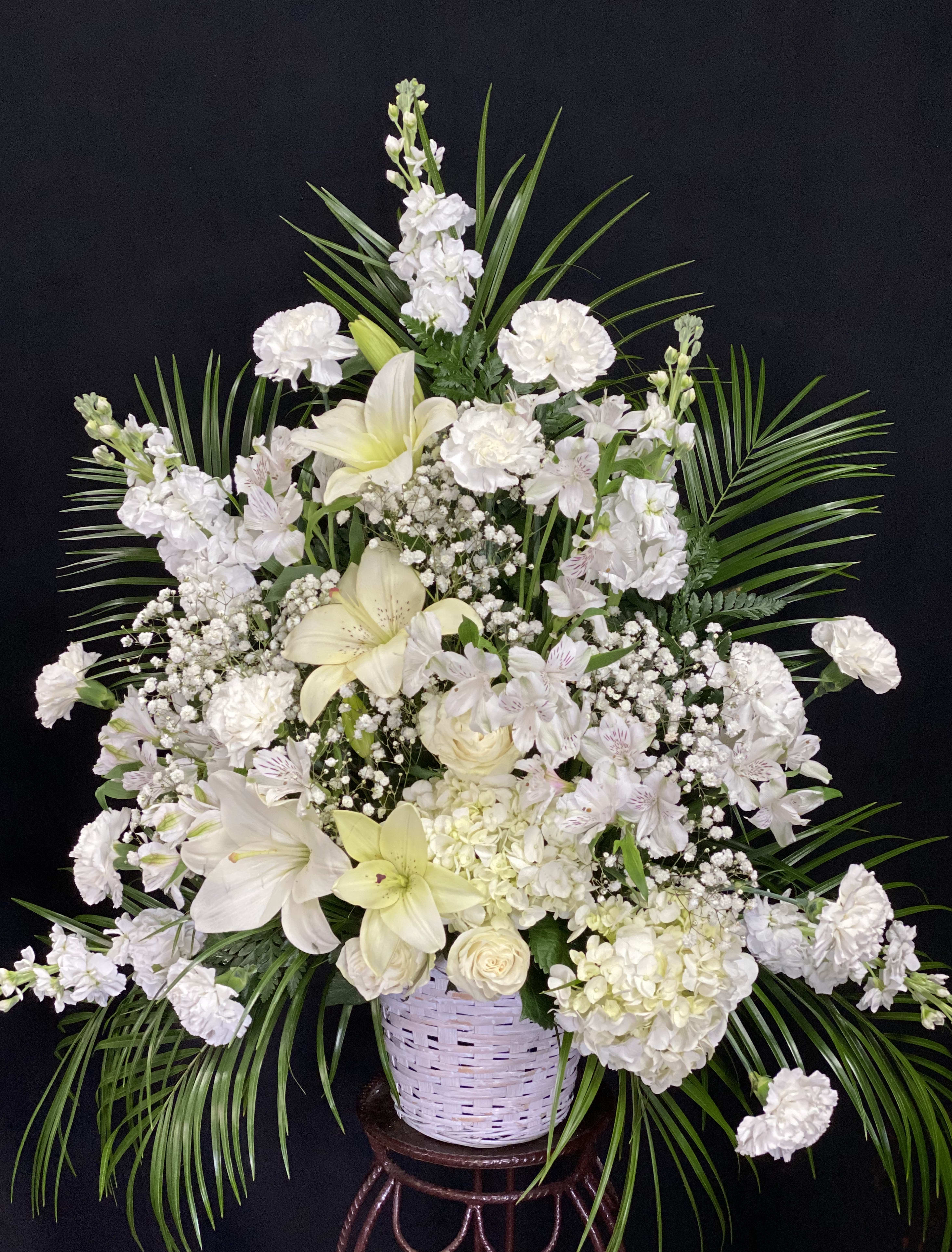 Sincerest Sympathy - The Sincerest Sympathy Arrangement is a wondrous presentation of grace and elegance to honor the life of loved one. All white piece of  roses, hydrangea, lilies, and carnations are offset by baby's breath and lush greens, gorgeously arranged to create a lovely way to express your warmest sentiments, offering comfort and peace with each bloom.