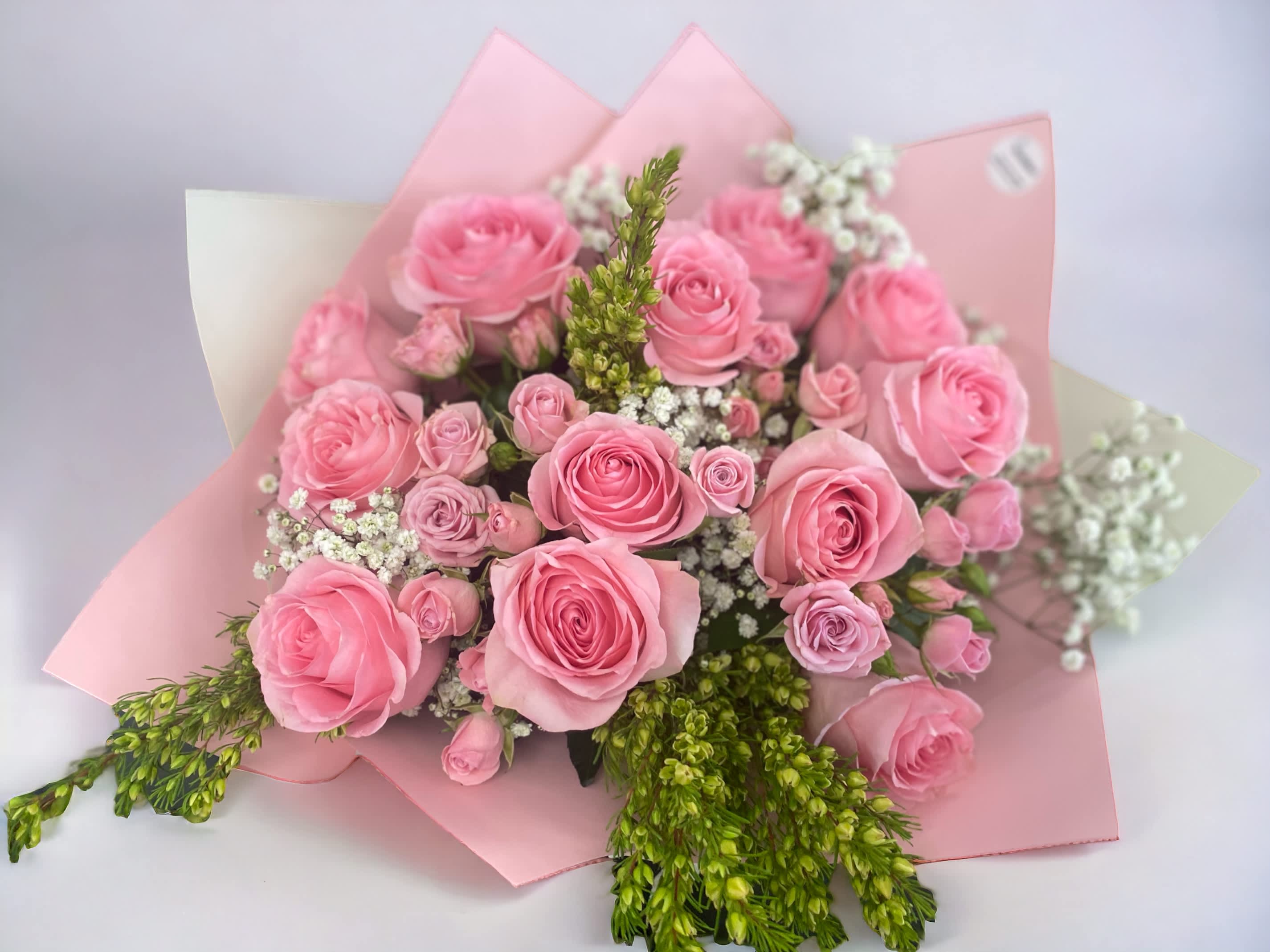 Pink roses and spray roses bouquet Pink roses and spray roses bouquet - A bouquet of 12 pink roses and spray roses bouquet for your loved ones. Deluxe is 18 roses. Premium is 24 roses. **Color of pink roses may vary** We offer different colors and styles for wrapping paper. Please note in Florist Instructions your choice of wrapping paper. We have one solid color like red, pink, white, classic brown, clear, etc. We also have two side colors like white/gold, light pink/hot pink, pink/purple, blue/white etc. And lastly, we have them in shiny/iridescent colors, or texture/style paper. Call us at 323-961-6686 if you have any questions.