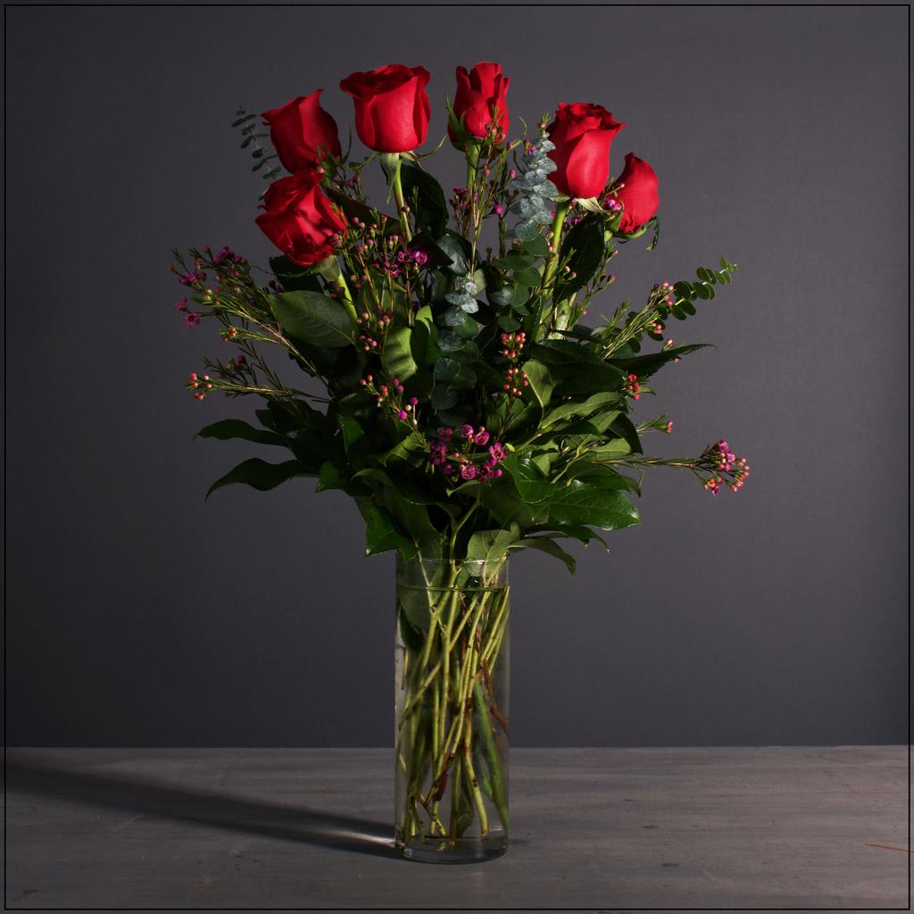 Half Doz. Premium Roses - 6 of our long stem roses with a mix of greens and waxflower. Please let us know if you would like a specific color.