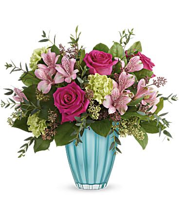 Enchanted Spring Bouquet - Spring has sprung! Capture the enchantment of the new season with this cheerful rose bouquet, perfectly presented in a gorgeous European glass vase in the most awe-inspiring shade of aqua.