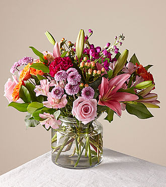 Candy Hearts Bouquet - This vibrant bouquet features roses, lilies, carnations &amp; more flowers to show your sweetheart just how much you care.  DETAILS The Good Bouquet is about 14&quot;H by 14&quot;W. Comes in a clear glass vase. For long–lasting blooms replace water and trim stems daily. The bouquet pictured reflects our original design for this product. While we always try to follow the color palette, we may replace stems to deliver the freshest bouquet possible, and we may sometimes need to use a different vase