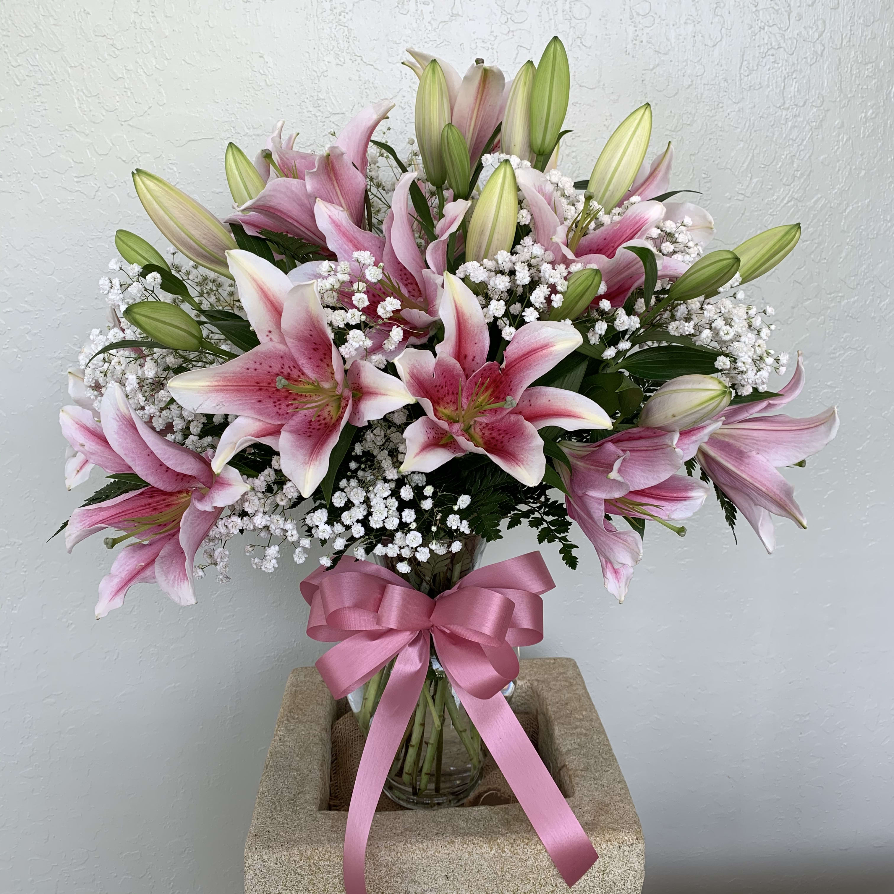 Fall in love with Stargazer  - Beautiful Stargazer lilies with baby breath bouquet in clear vase.  Standard: 6 stems lilies Deluxe:  10 stems lilies Premium: 15 stems lilies (Shown as a picture)
