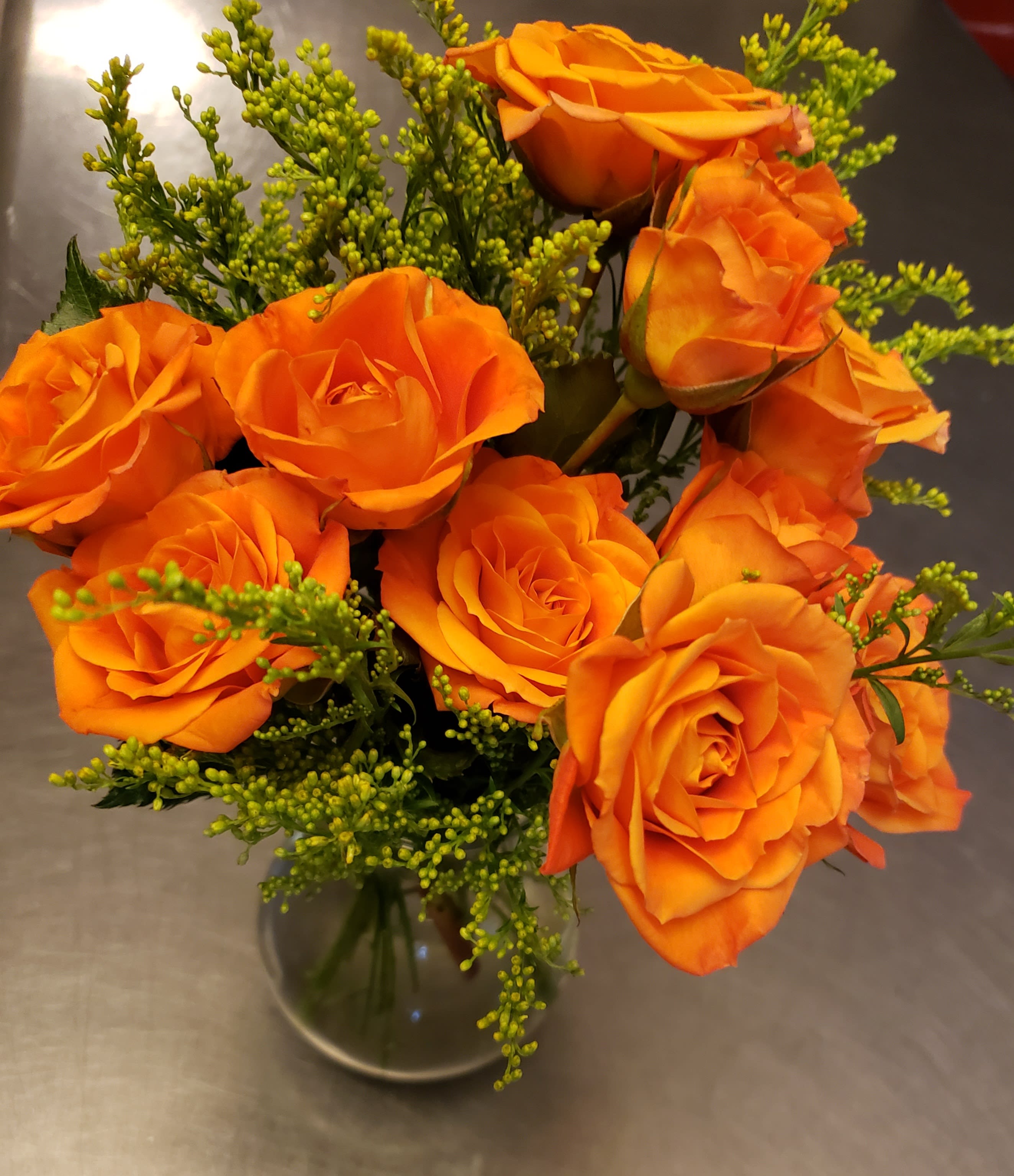Love in the Clouds Love in the Clouds - Clouds of filler flowers surround a beautiful bundle of spray roses in a 5" clear vase. This adorable little arrangement packs a big punch. Deliver this to a friend or sweetheart, they will love you for it! Perfect presentation