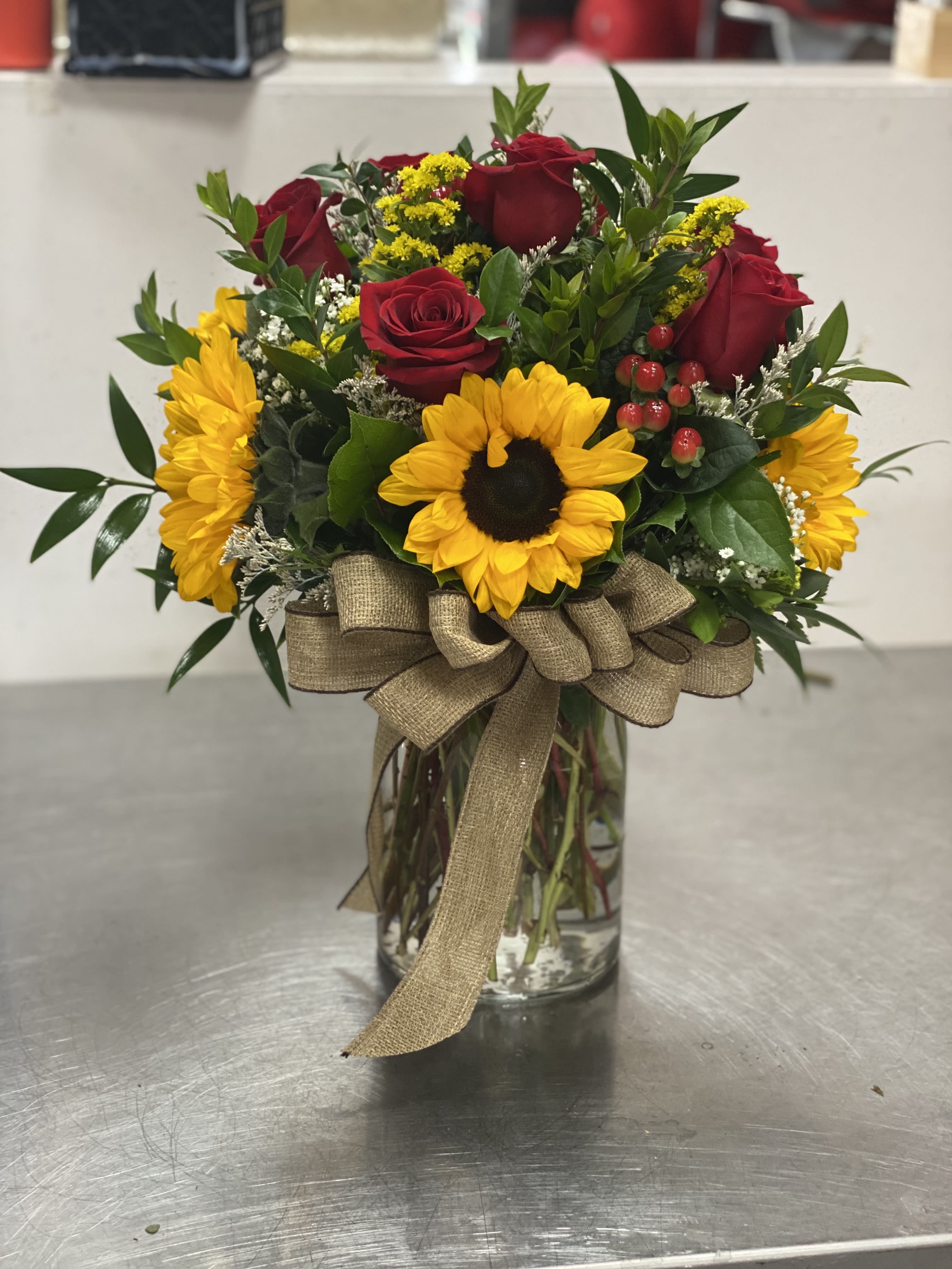 Regular Roses and Sunflowers Regular Roses and Sunflowers - This popular 8” vase arrangement is of our popular styles. 8 roses and sunflowers all around filled with just the right fillers make it work for almost all occasions.