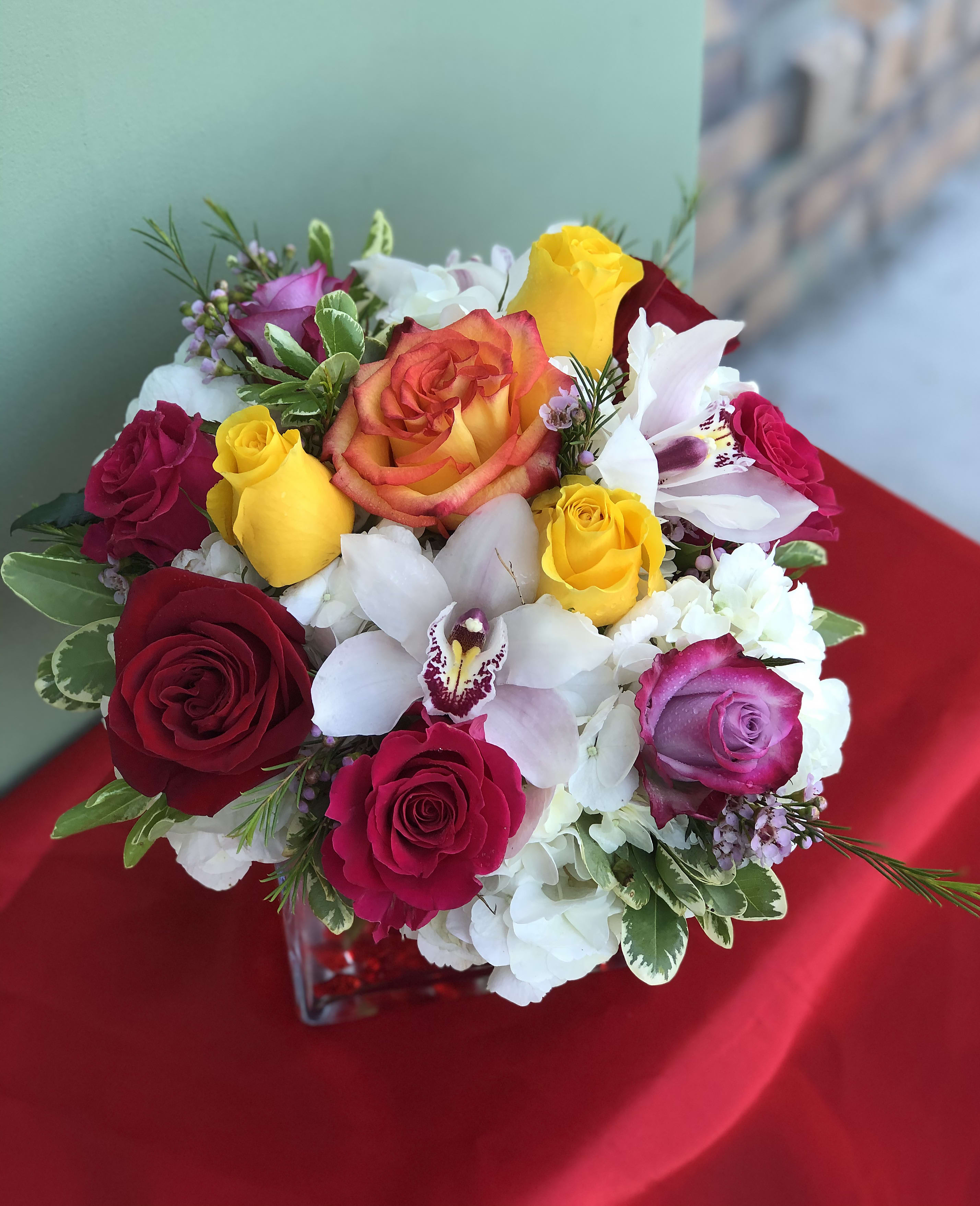 Garden Of Eden  - Joyful arrangement of Roses, Orchids, Hydrangeas, and Greens designed in a vase with decorative crystals. Give the gift of color to your special one!