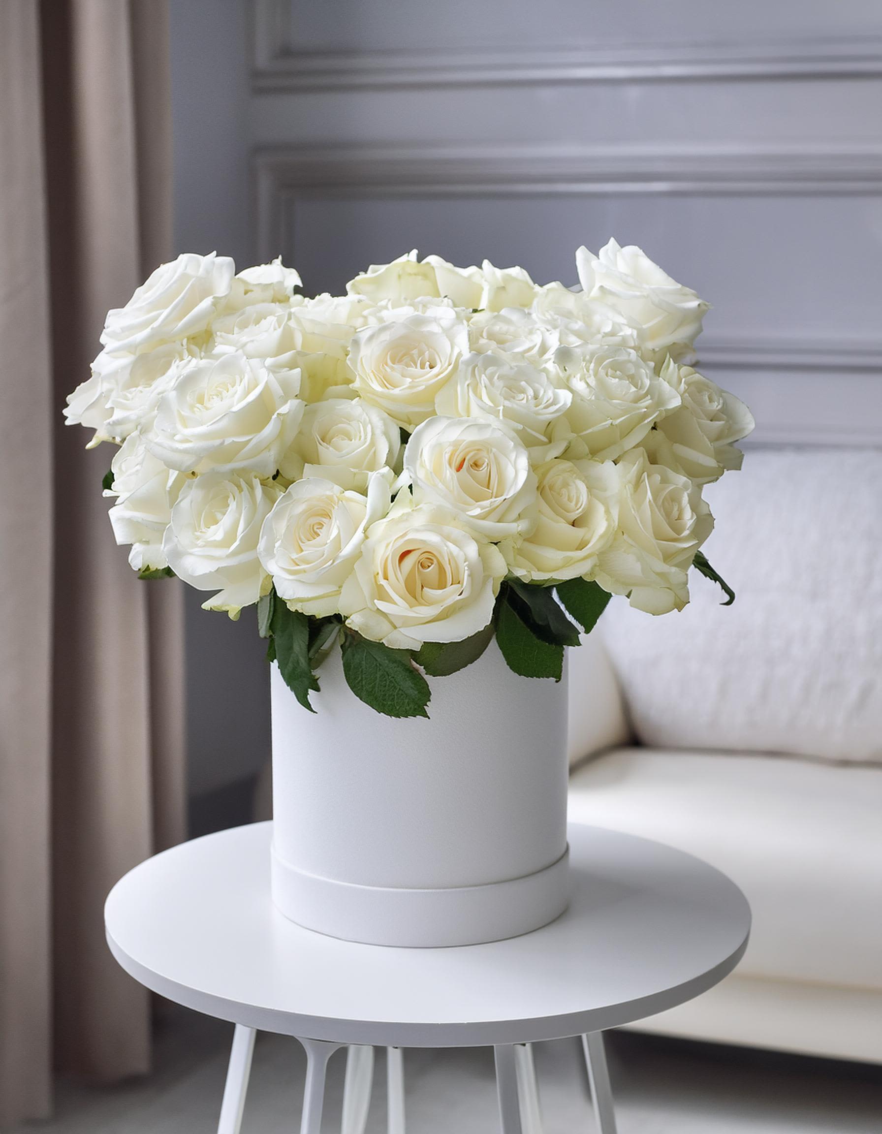 White Elegance White Elegance - Make a statement with our stunning white roses in a chic white hatbox. Ideal for weddings, anniversaries, or just because, this arrangement is a symbol of pure elegance. Elevate any space with this beautiful floral display.