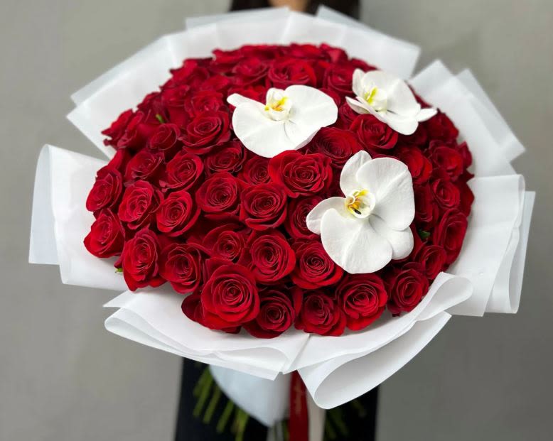 love in Bloom  - Love in Bloom &quot; Red Roses and Orchid Bouquet&quot;  **75 Roses shown in the First picture   Our &quot;Love Is&quot; bouquet is a passionate expression of affection and devotion. Crafted with the finest red roses and crowned with a graceful orchid on top, this arrangement symbolizes love's profound beauty and elegance. Whether it's an anniversary, a romantic gesture, or simply a way to say &quot;I love you,&quot; this bouquet speaks volumes.  2 Dozen+4 30 premium roses  Bouquet: Comes with 1 exquisite orchid 3 Dozen Bouquet: Features 2 stunning orchids for added charm 4 Dozen and more: Showcases 3 delicate orchids for maximum impact Experience the enchantment of our &quot;Love In Bloom&quot; bouquet and let its beauty convey the depth of your emotions. It's a timeless gift that encapsulates the essence of love itself.
