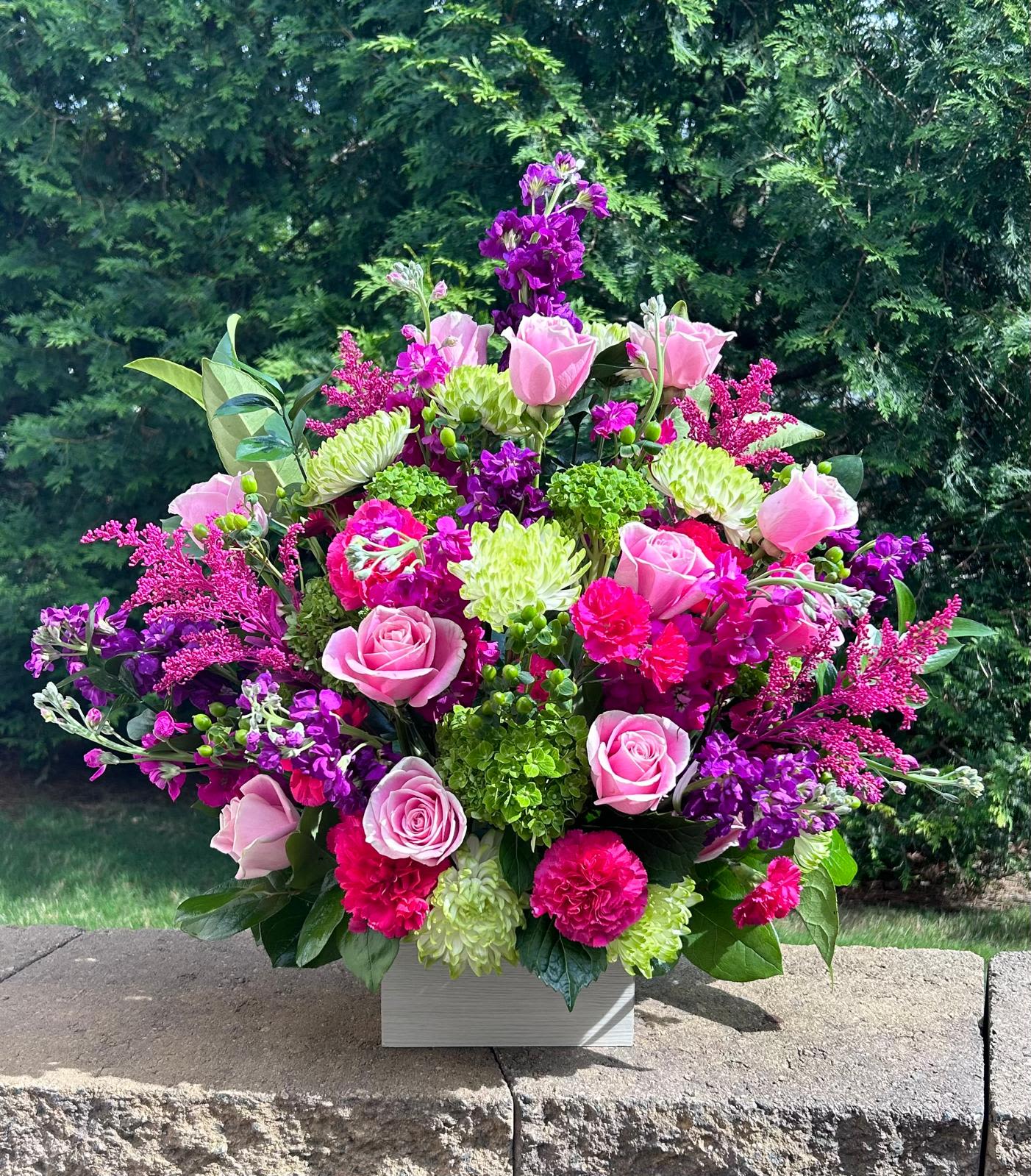 Margareta Wooden Box - Fresh flower arrangement along fine foliage. WHITEWASHED WOODEN BOX Place your Order Online Monday to Saturday before 1:00 p.m. (E.T.) for same-day delivery. “Orders received after hours will be delivered the next business day”. Check our coverage area. Occasionally, substitutions of flowers and/or containers happen due to weather, seasonality, and market conditions which may affect availability. If this is the case with the gift you’ve selected, we will ensure that the style, theme, and color scheme of your arrangement are preserved and will only substitute items of equal value or higher value. 