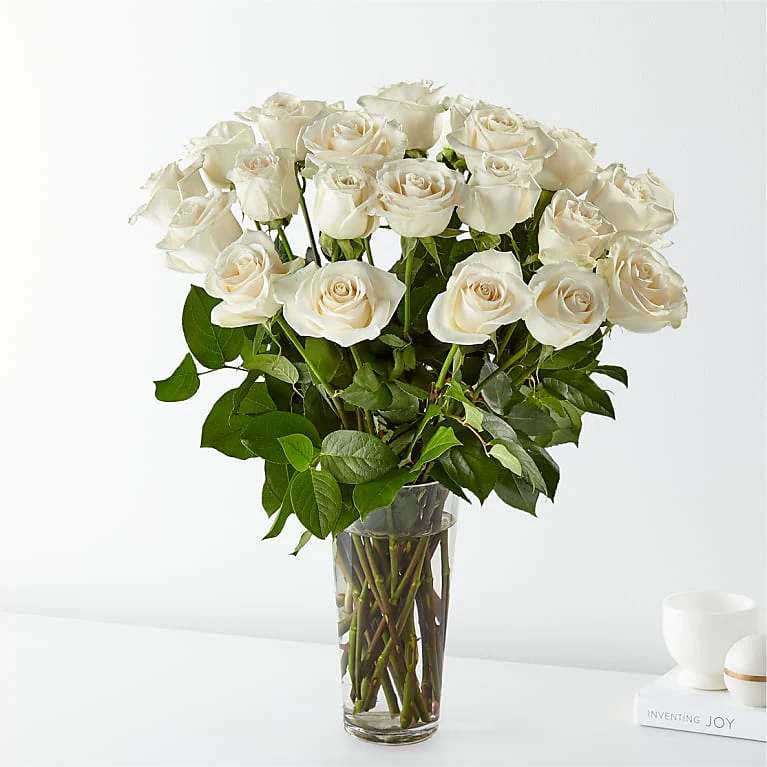 Long Stems White Rose - 24 White Roses Deluxe All Occasion Clear Glass  Place your Order Online Monday to Saturday before 1:00 p.m. (E.T.) for same-day delivery.  “Orders received after hours will be delivered the next business day”. Check our coverage area. Occasionally, substitutions of flowers and/or containers happen due to weather, seasonality, and market conditions which may affect availability. If this is the case with the gift you’ve selected, we will ensure that the style, theme, and color scheme of your arrangement are preserved and will only substitute items of equal value or higher value.  CARE INSTRUCTIONS	 Keep the flower arrangement hydrated with natural water and change the water every two days. Do not spray any cleaning product on the flower arrangement. Do not place heavy objects directly on the flower arrangement. Keep flower arrangements out of direct sunlight and extreme heat. 