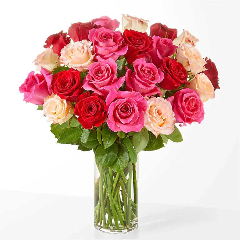 Mix Rose Bouquet - Make them blush with this bright blend of white, hot pink and red roses, the timeless way to share an &quot;I love you.&quot; 24 stems of roses All Occasion Glass Pot • Place your Order Online Monday to Saturday before 1:00 p.m. (E.T.) for same-day delivery. • “Orders received after hours will be delivered the next business day”. • Check our coverage area. • Occasionally, substitutions of flowers and/or containers happen due to weather, seasonality, and market conditions which may affect availability. If this is the case with the gift you’ve selected, we will ensure that the style, theme, and color scheme of your arrangement are preserved and will only substitute items of equal value or higher value.  CARE INSTRUCTIONS Keep the flower arrangement hydrated with natural water and change the water every two days. Do not spray any cleaning product on the flower arrangement. Do not place heavy objects directly on the flower arrangement. Keep flower arrangements out of direct sunlight and extreme heat.