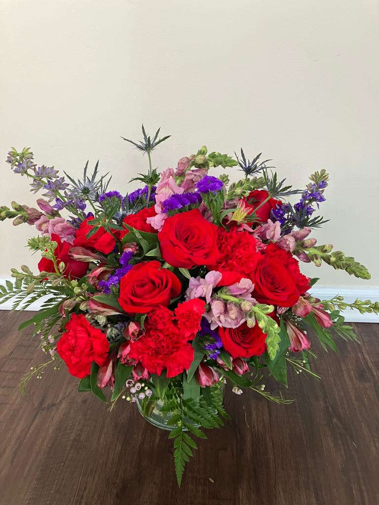 Shades of Love - Fresh flower arrangement along fine foliage. Bloom Details: Snaps/Stock, Roses, Thiesel, Carnations, Statice, Alstro Glass Pot. Place your Order Online Monday to Saturday before 1:00 p.m. (E.T.) for same-day delivery.  “Orders received after hours will be delivered the next business day”. Check our coverage area. Occasionally, substitutions of flowers and/or containers happen due to weather, seasonality, and market conditions which may affect availability. If this is the case with the gift you’ve selected, we will ensure that the style, theme, and color scheme of your arrangement are preserved and will only substitute items of equal value or higher value.   CARE INSTRUCTIONS	 Keep the flower arrangement hydrated with natural water and change the water every two days. Do not spray any cleaning product on the flower arrangement. Do not place heavy objects directly on the flower arrangement. Keep flower arrangements out of direct sunlight and extreme heat. 