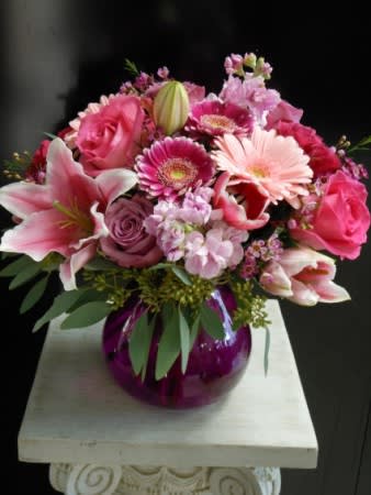 Pinkification Pinkification - Jennifer Lee's own design with a lavender vase filled with pinks: gerberas, roses, lilies and stock, rimmed with seeded eucalyptus.