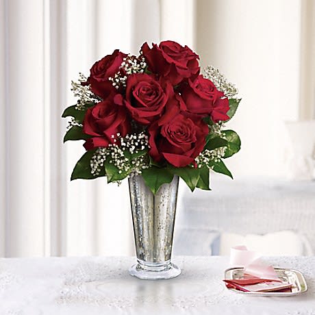 Kiss of the Rose Kiss of the Rose - Standard (shown): 6 Roses, Deluxe: 9 Roses, Premium: 12 Roses, Traditional elegance. A handful of classic red roses look especially stunning in a silver mercury vase accented with delicate, and babies breath.