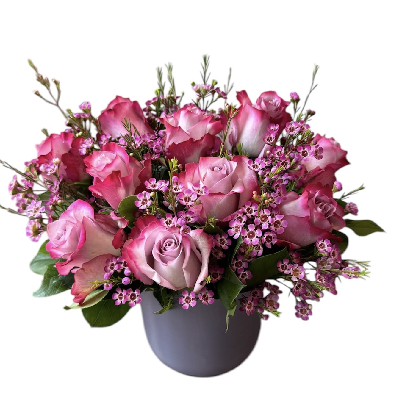 Kiss me - 1 dozen Lavendar roses in a purple glass vase with wax flower as shown. 