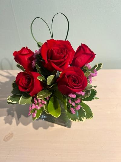 Sweet Thoughts Bouquet with Red Roses Sweet Thoughts Bouquet with Red Roses - A Half dozen roses in a 4 inch by 4 inch cube or cylinder vase. If you'd like someone to think sweet thoughts about you send them this delightful bouquet! A graceful heart made out of bear grass that floats above red roses with pink statice is nestled in a clear glass vase. How sweet it is!
