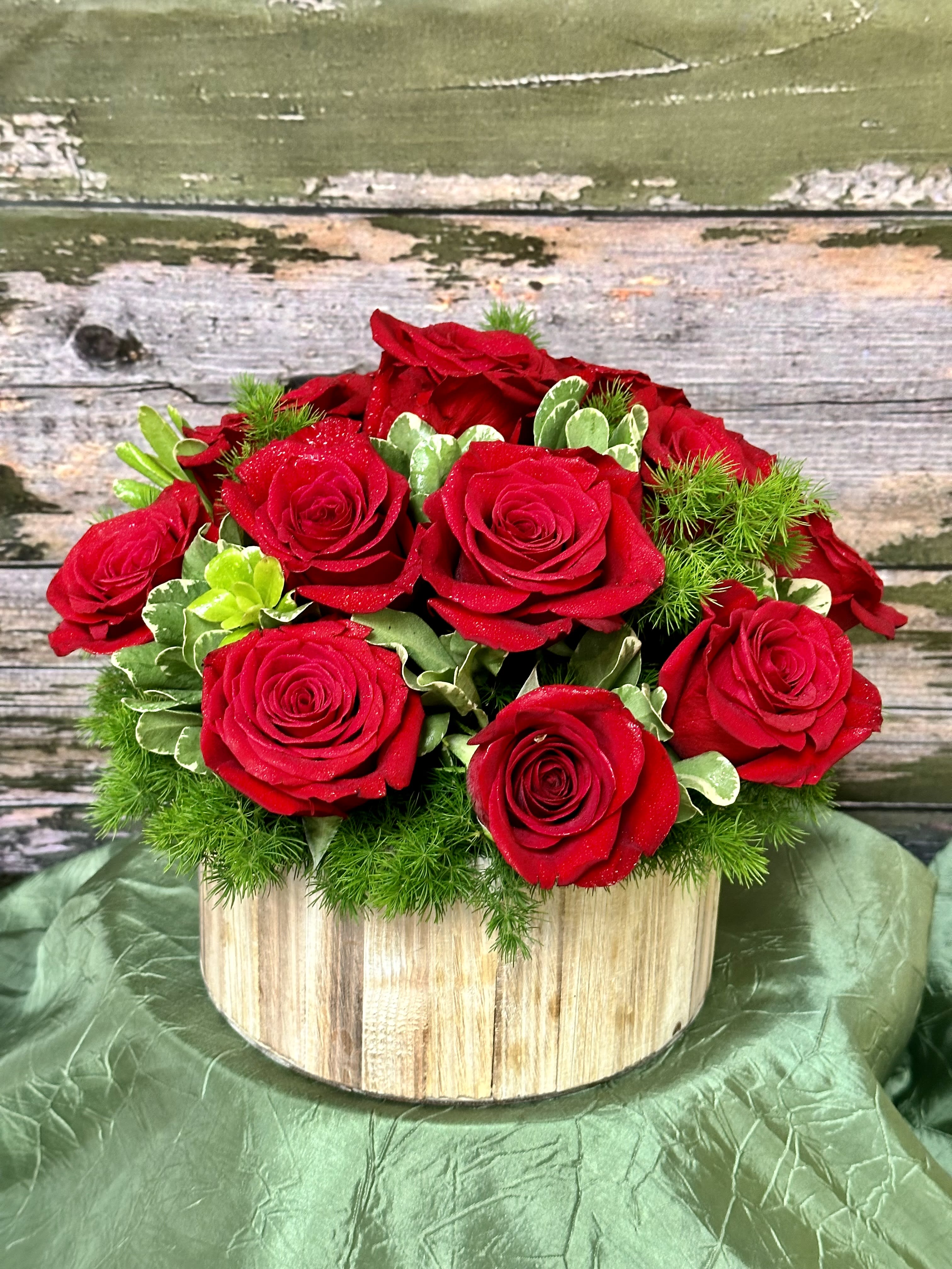 Circle of Love Circle of Love - Enjoy 15 Red Roses Nestled In Mixed Greenry! Arrives in a Wooden Circular Planter.