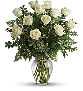 Dozen Long Stemmed White Roses Dozen Long Stemmed White Roses - Beautiful white roses arranged in a glass vase with mixed greenery.